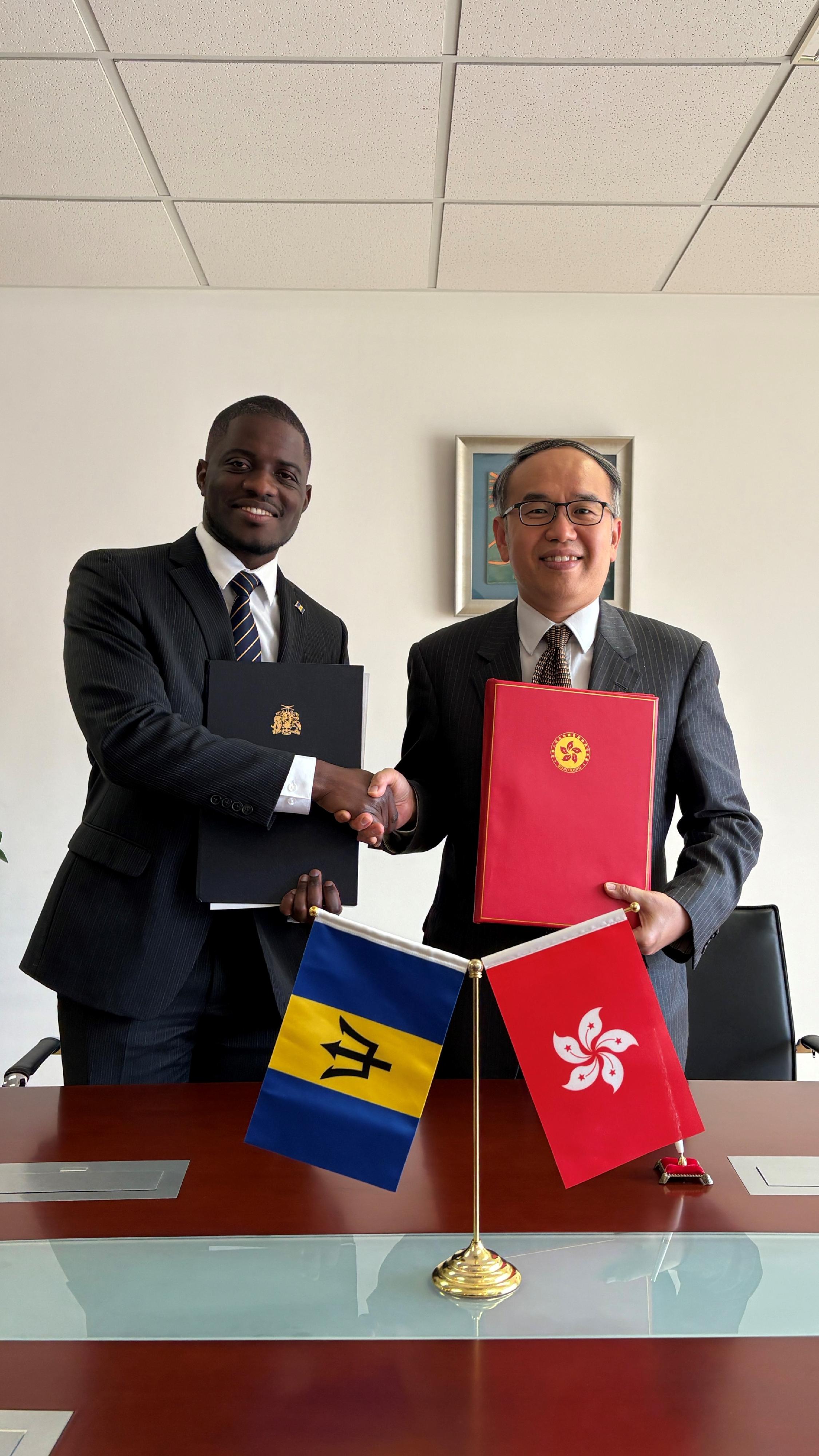 The Secretary for Financial Services and the Treasury, Mr Christopher Hui (right), and the Ambassador of Barbados to China, Mr Hallam Henry (left), signed on behalf of the Hong Kong Special Administrative Region Government and the Government of Barbados respectively a comprehensive avoidance of double taxation agreement in Beijing today (March 19). Photo shows Mr Hui and Mr Henry at the signing ceremony.