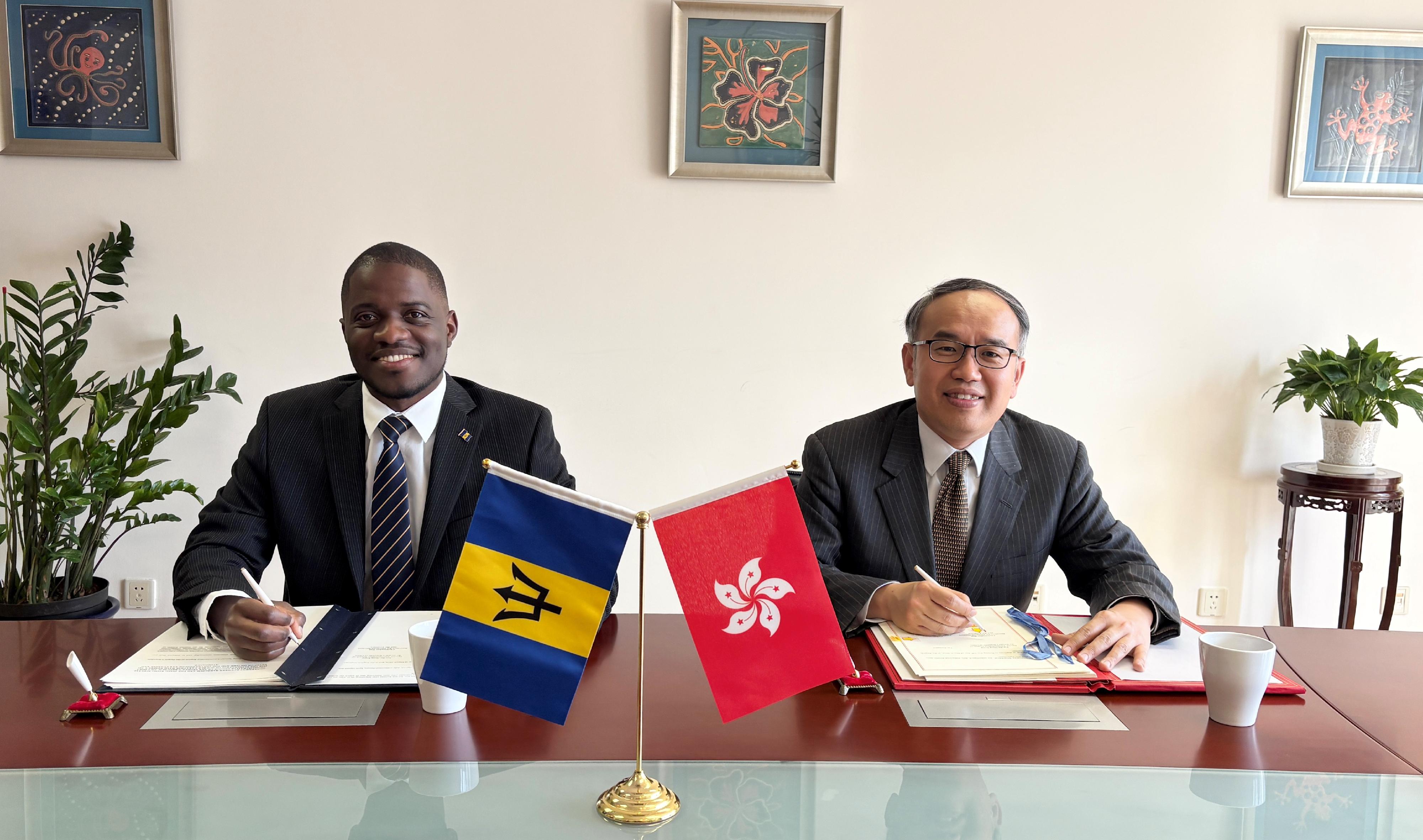 The Secretary for Financial Services and the Treasury, Mr Christopher Hui (right), and the Ambassador of Barbados to China, Mr Hallam Henry (left), sign on behalf of the Hong Kong Special Administrative Region Government and the Government of Barbados respectively a comprehensive avoidance of double taxation agreement in Beijing today (March 19).