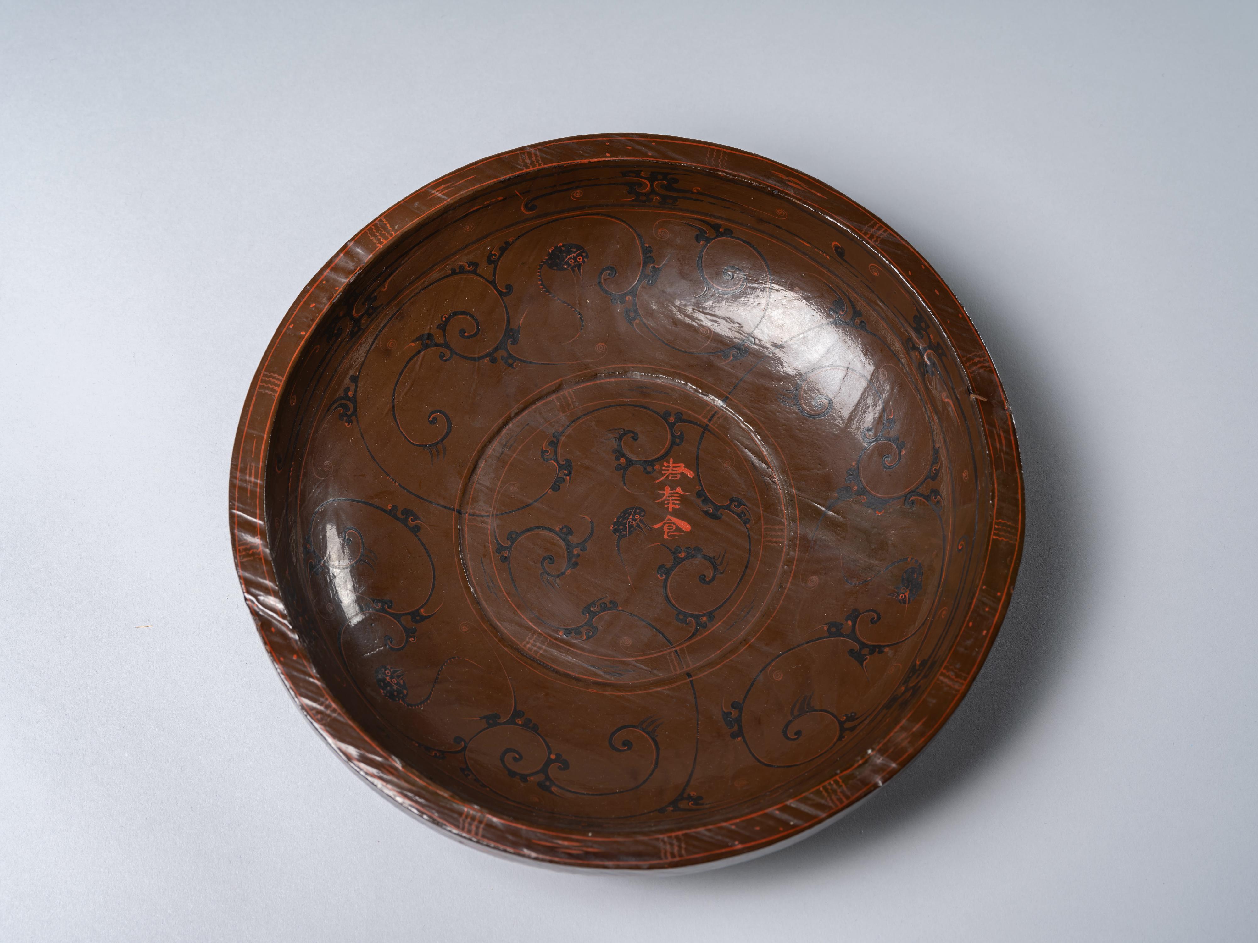 The opening ceremony of the exhibition titled &ldquo;The Majestic Han: A Golden Age of Vigour and Cultural Integration&rdquo; was held today (March 19) at the Hong Kong Heritage Discovery Centre. Photo shows a lacquered wooden plate with leopard cat motif and Chinese characters Jun Xing Shi (food for the honoured guest).
