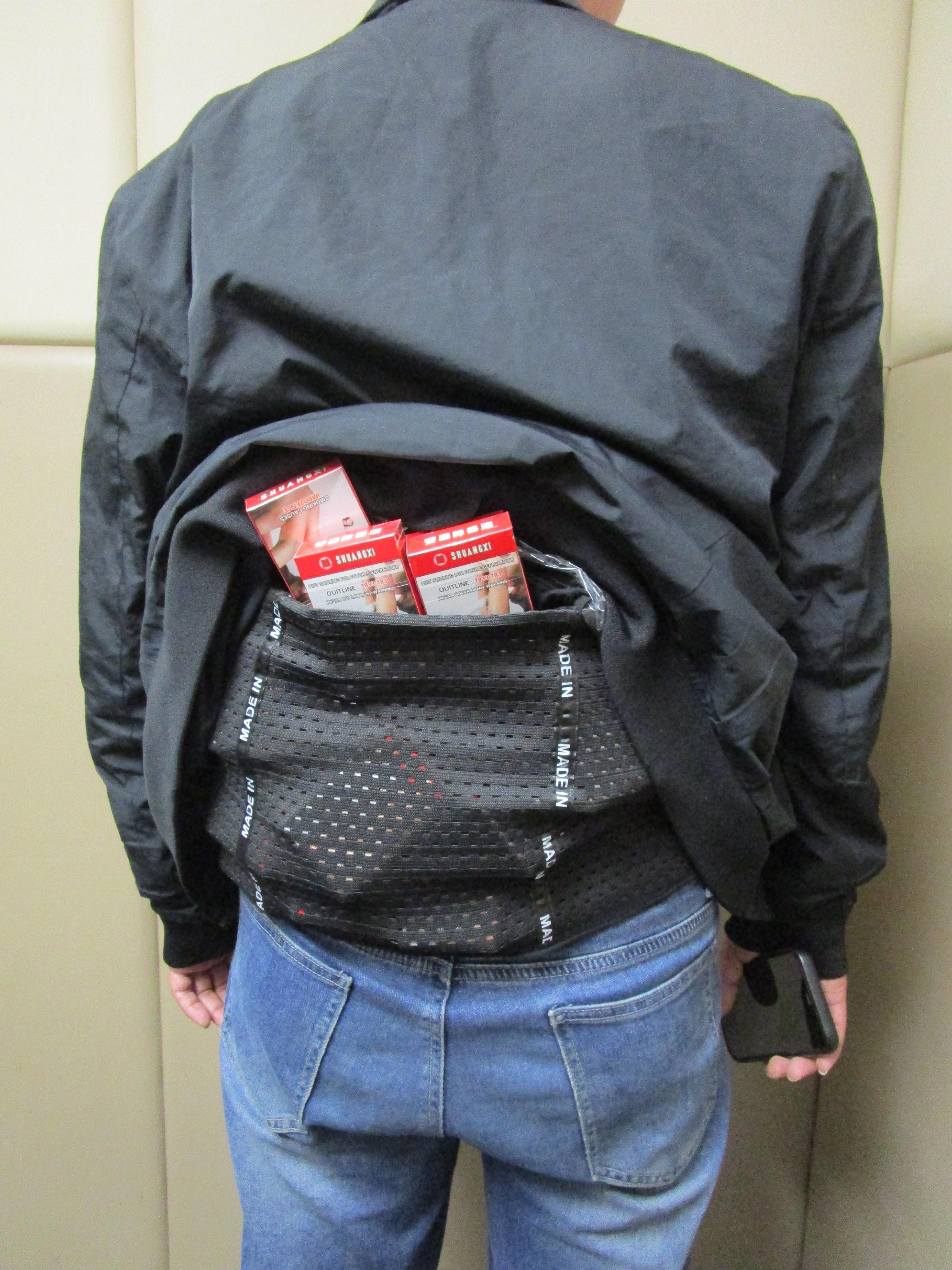 Two incoming passengers were respectively sentenced to eight weeks' imprisonment with a fine of $4,000 and four weeks&rsquo; imprisonment with a fine of $2,000 by the Fanling Magistrates' Courts today (March 20) for importing duty-not-paid cigarettes and failing to declare them to Customs officers, in contravention of Dutiable Commodities Ordinance. Photo shows a 38-year-old incoming male passenger with duty-not-paid cigarettes concealed in a waistband.