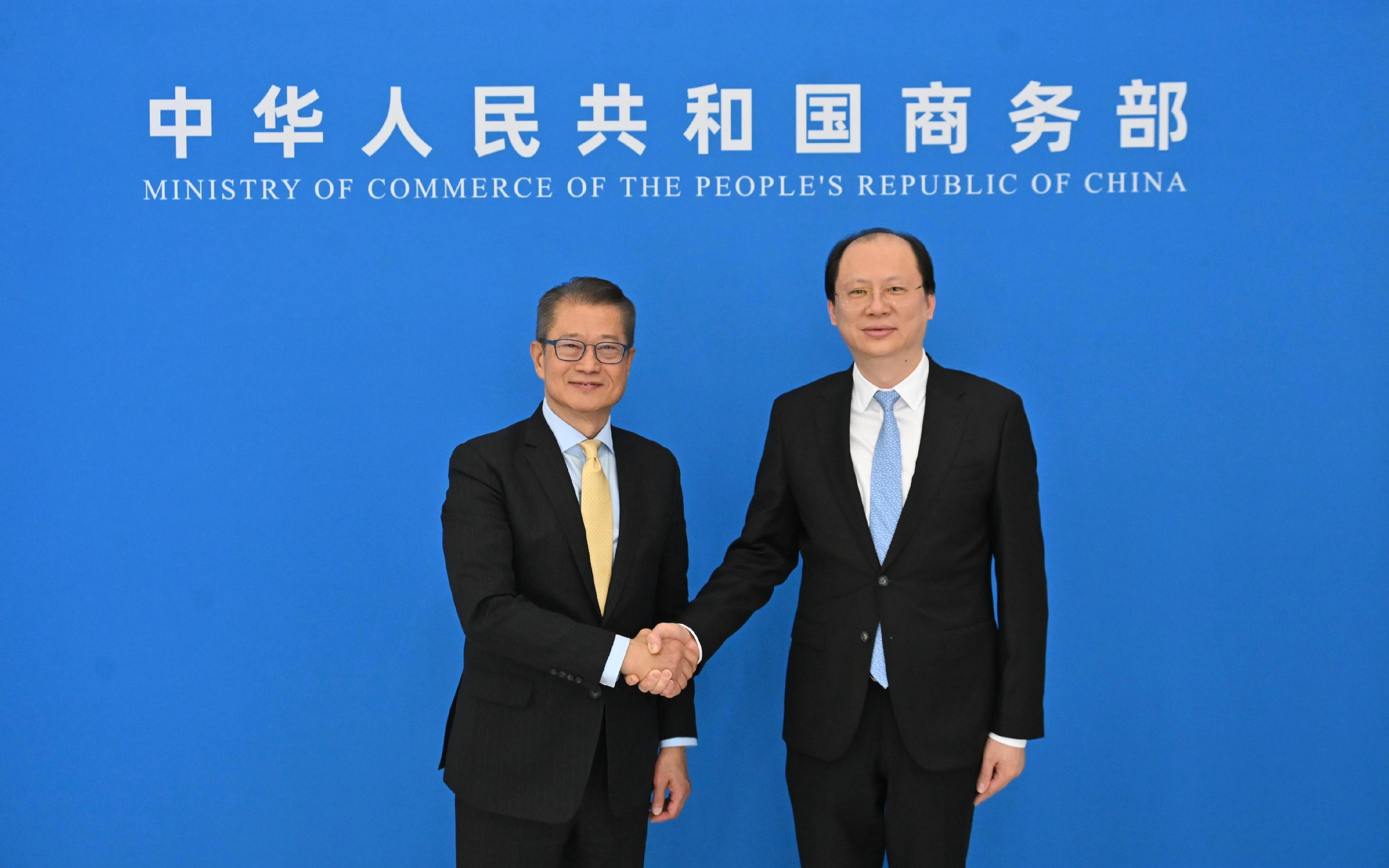 財政司司長陳茂波（左）今日（三月二十三日）在北京與國家商務部部長助理袁曉明（右）共同主持內地與香港經貿合作委員會第八次會議。
