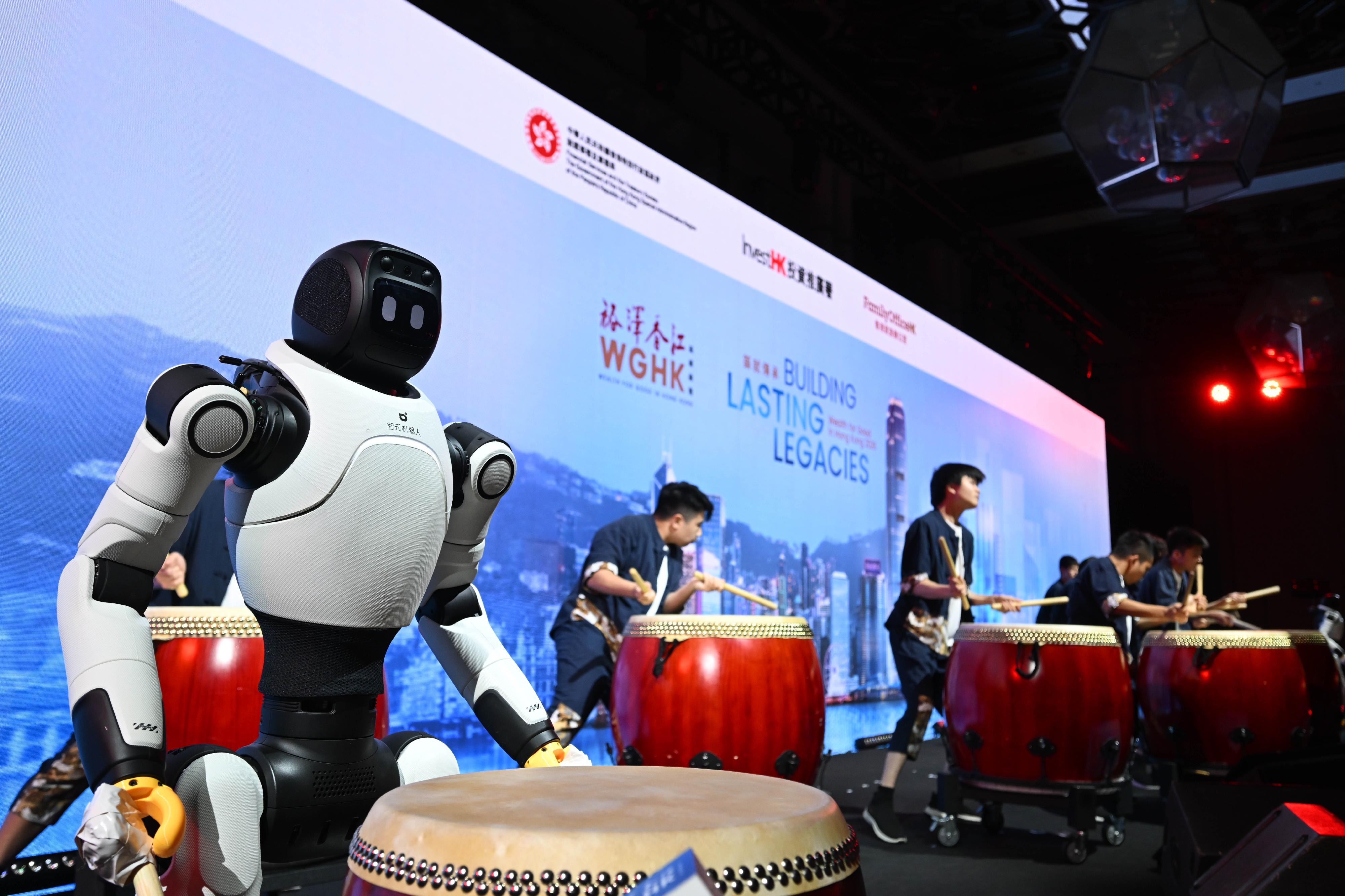 The Diocesan Boys' School Chinese Drum Team and robotic drummers perform a joint ensemble at the opening of the Wealth for Good in Hong Kong Summit today (March 24), showcasing the integration and coexistence of traditional arts and cutting-edge technology.