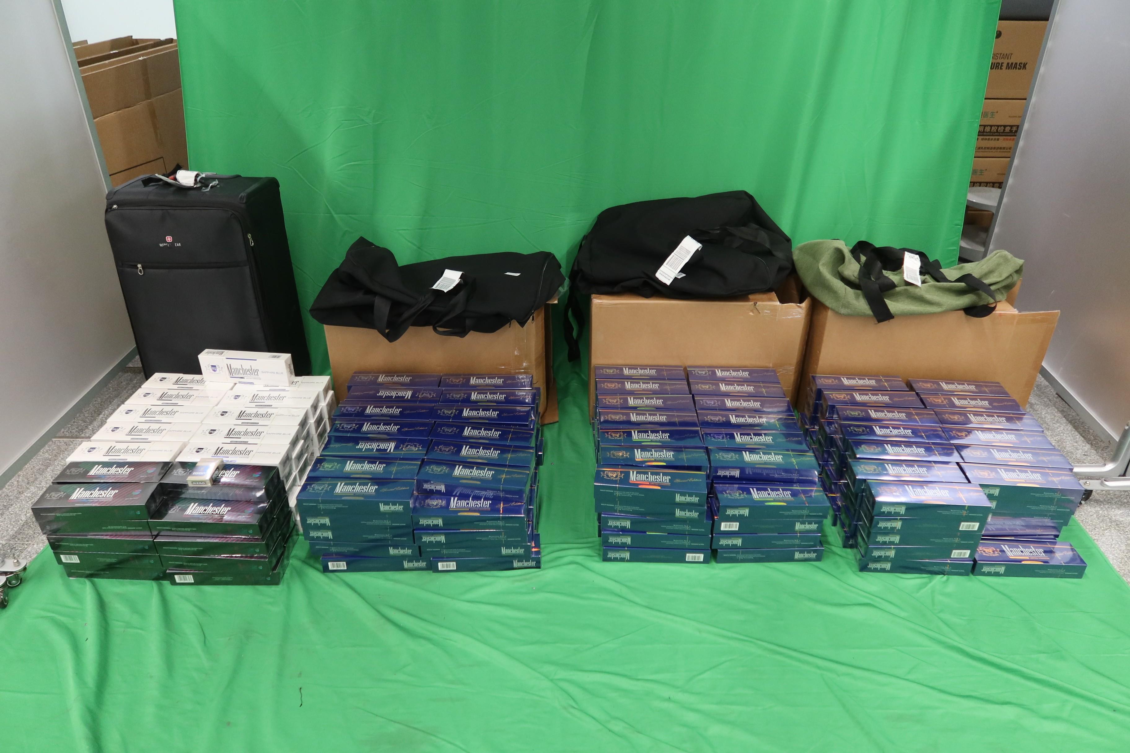 Two incoming passengers were sentenced to six months' imprisonment and fined $500, and two months' imprisonment and fined $1,000 respectively by the West Kowloon Magistrates' Courts today (March 25) for importing duty-not-paid cigarettes and failing to declare them to Customs officers, in contravention of the Dutiable Commodities Ordinance. Photo shows the duty-not-paid cigarettes seized from the personal baggage of a 38-year-old male incoming passenger. 

