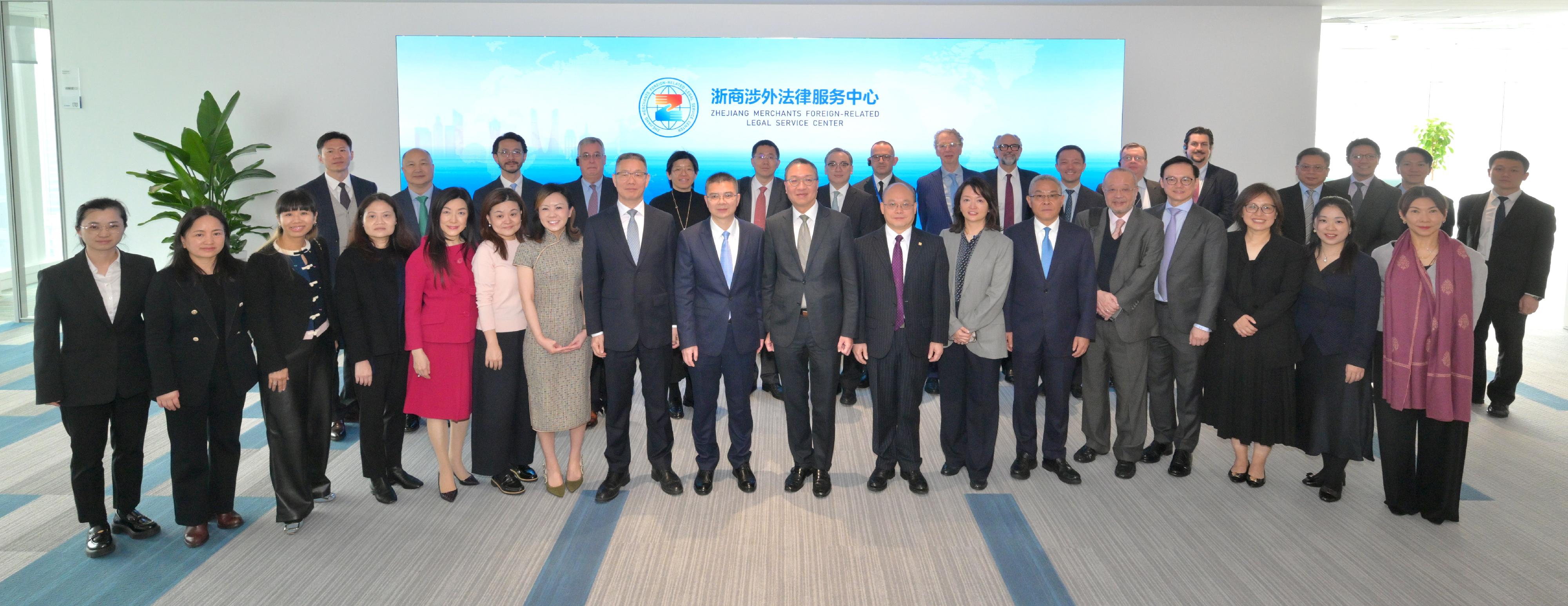 The Secretary for Justice, Mr Paul Lam, SC, together with his delegation, visited the Zhejiang Merchants Foreign-Related Legal Service Center in Hangzhou today (March 25) to learn about the current state of foreign-related legal services in Zhejiang Province. Photo shows Mr Lam (front row, tenth left); the Director of the Hong Kong Economic and Trade Office in Shanghai of the Government of the Hong Kong Special Administrative Region, Ms Veronica Wong (front row, seventh right); and the Principal Government Counsel of the Legal Enhancement and Development Office of the Department of Justice, Ms Peggy Au Yeung (front row, third left), with representatives of the Center.