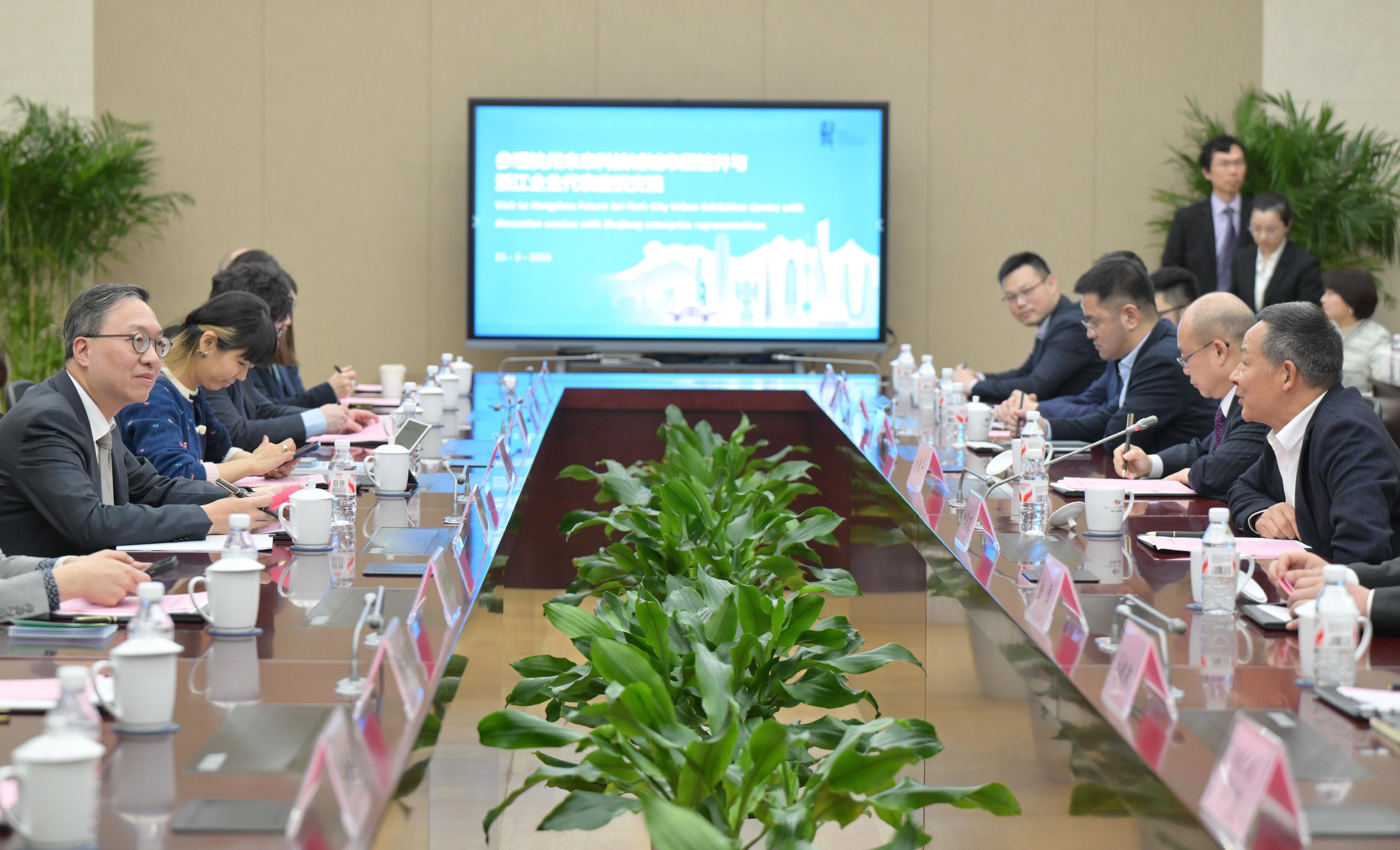 The Secretary for Justice, Mr Paul Lam, SC, together with his delegation, visited the Hangzhou Future Sci-Tech City Urban Exhibition Center today (March 25) to gain insights into Hangzhou's advancements in areas including smart city development and AI. Photo shows Mr Lam (first left) attending an exchange session with Zhejiang enterprise representatives after the visit.