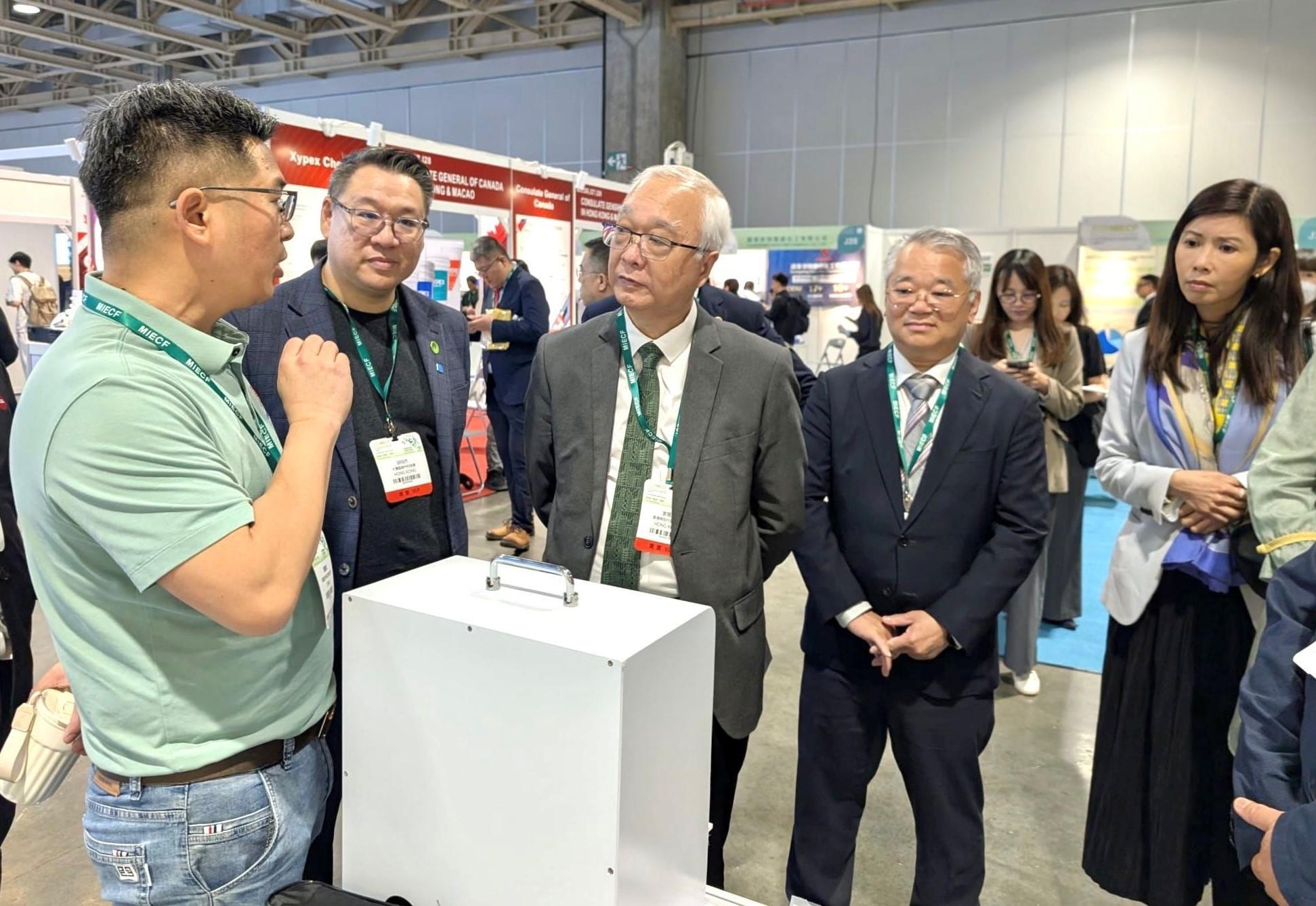 環境及生態局局長謝展寰今日（三月二十六日）在澳門出席二○二六年澳門國際環保合作發展論壇及展覽。圖示謝展寰（中）和環境保護署署長徐浩光博士（右二）與參展商交流。