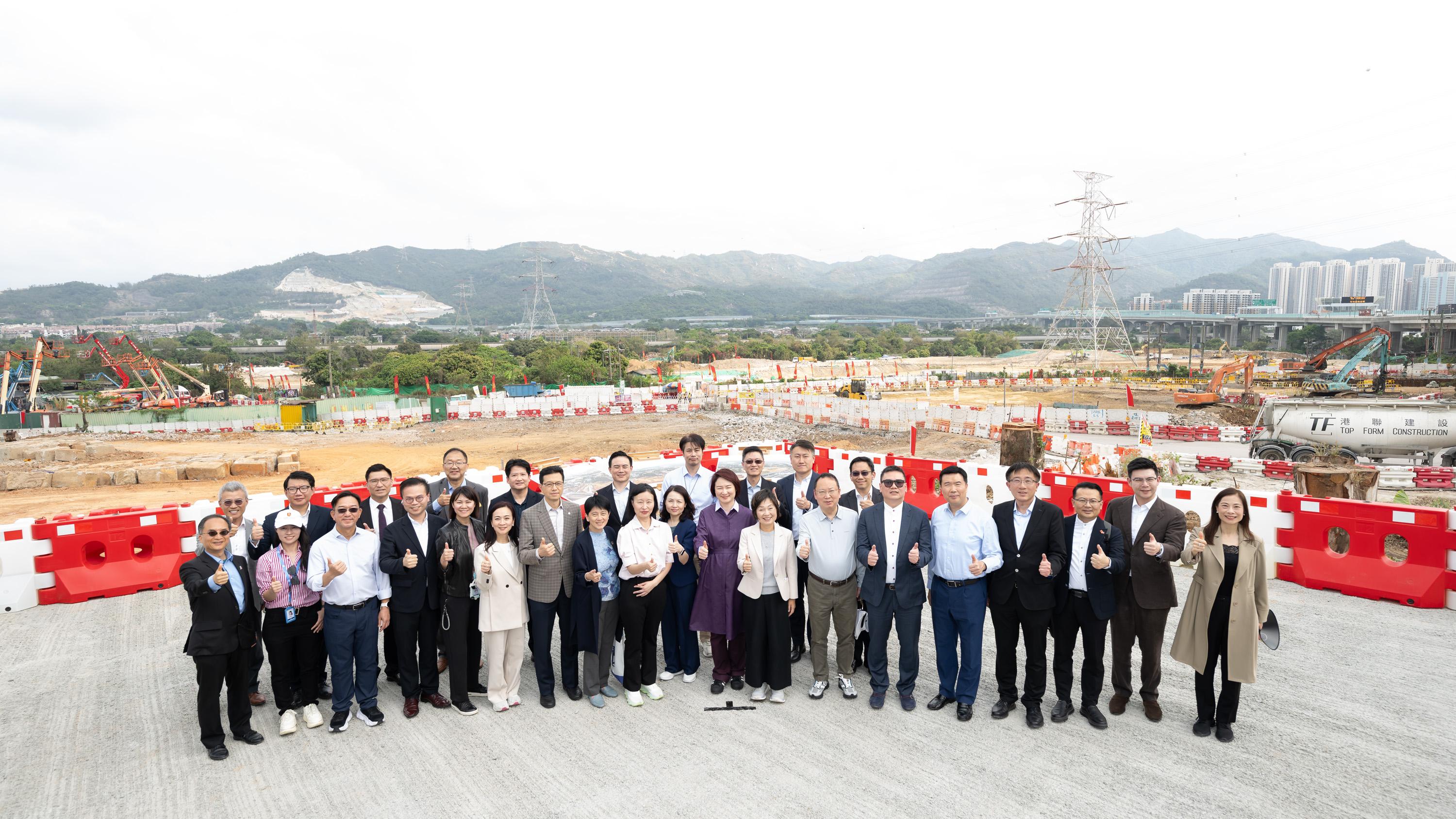 Members of the Legislative Council (LegCo) visited the Northern Metropolis (NM) today (March 26). Photo shows LegCo Members with government officials at the site for developing the NM University Town in Hung Shui Kiu/Ha Tsuen New Development Area.
