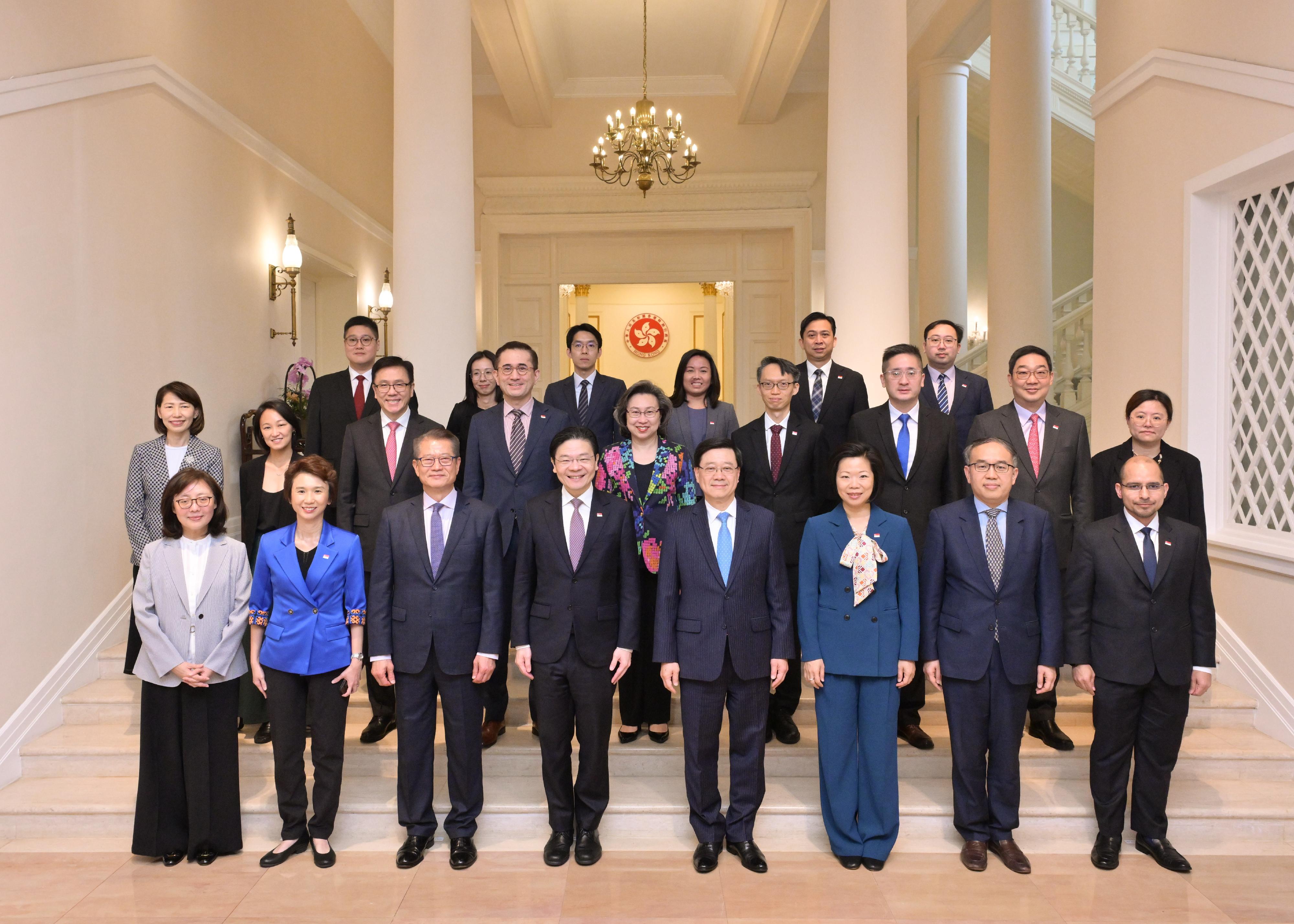 The Chief Executive, Mr John Lee (first row, fourth right), meets with the visiting Prime Minister and Minister for Finance of Singapore, Mr Lawrence Wong (first row, fourth left), at Government House today (March 27).