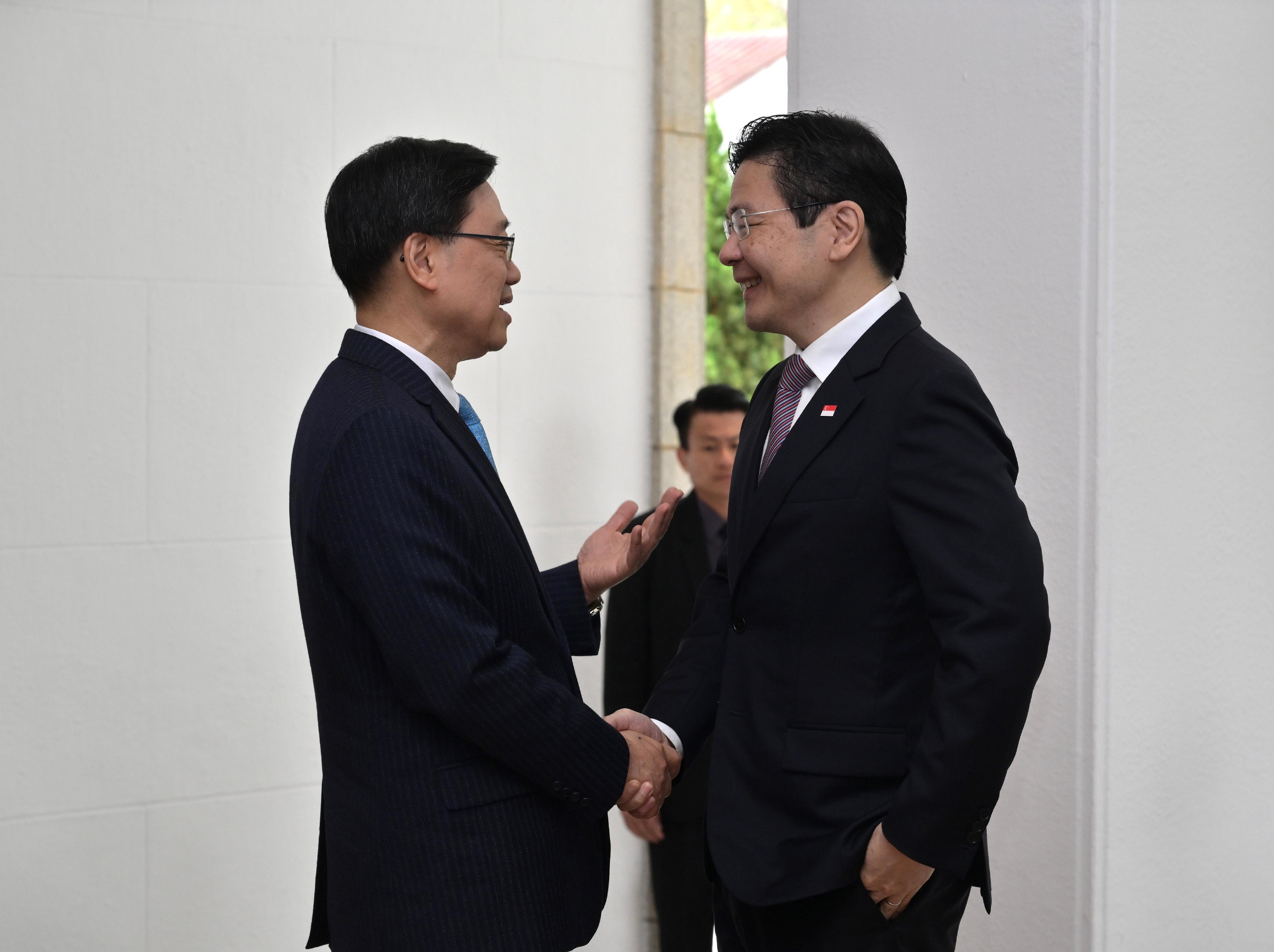 The Chief Executive, Mr John Lee (left), meets with the visiting Prime Minister and Minister for Finance of Singapore, Mr Lawrence Wong (right), at Government House today (March 27). 