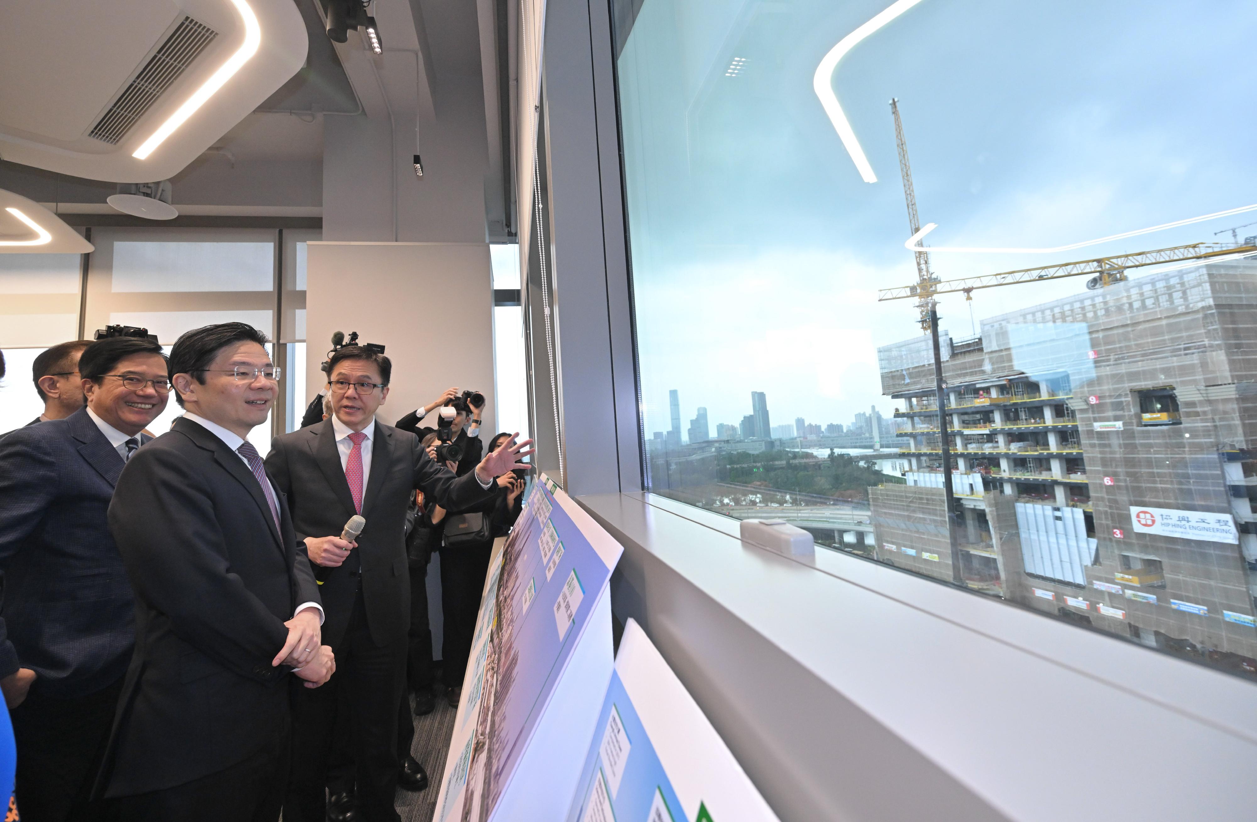 The Prime Minister and Minister for Finance of Singapore, Mr Lawrence Wong, visited the Hong Kong Park of the Hetao Shenzhen-Hong Kong Science and Technology Innovation Co-operation Zone (the Hong Kong Park in the Loop) in the Northern Metropolis today (March 27). Photo shows Mr Wong (second left) being briefed by the Secretary for Innovation, Technology and Industry, Professor Sun Dong (third left) on the Hong Kong Park in the Loop.
