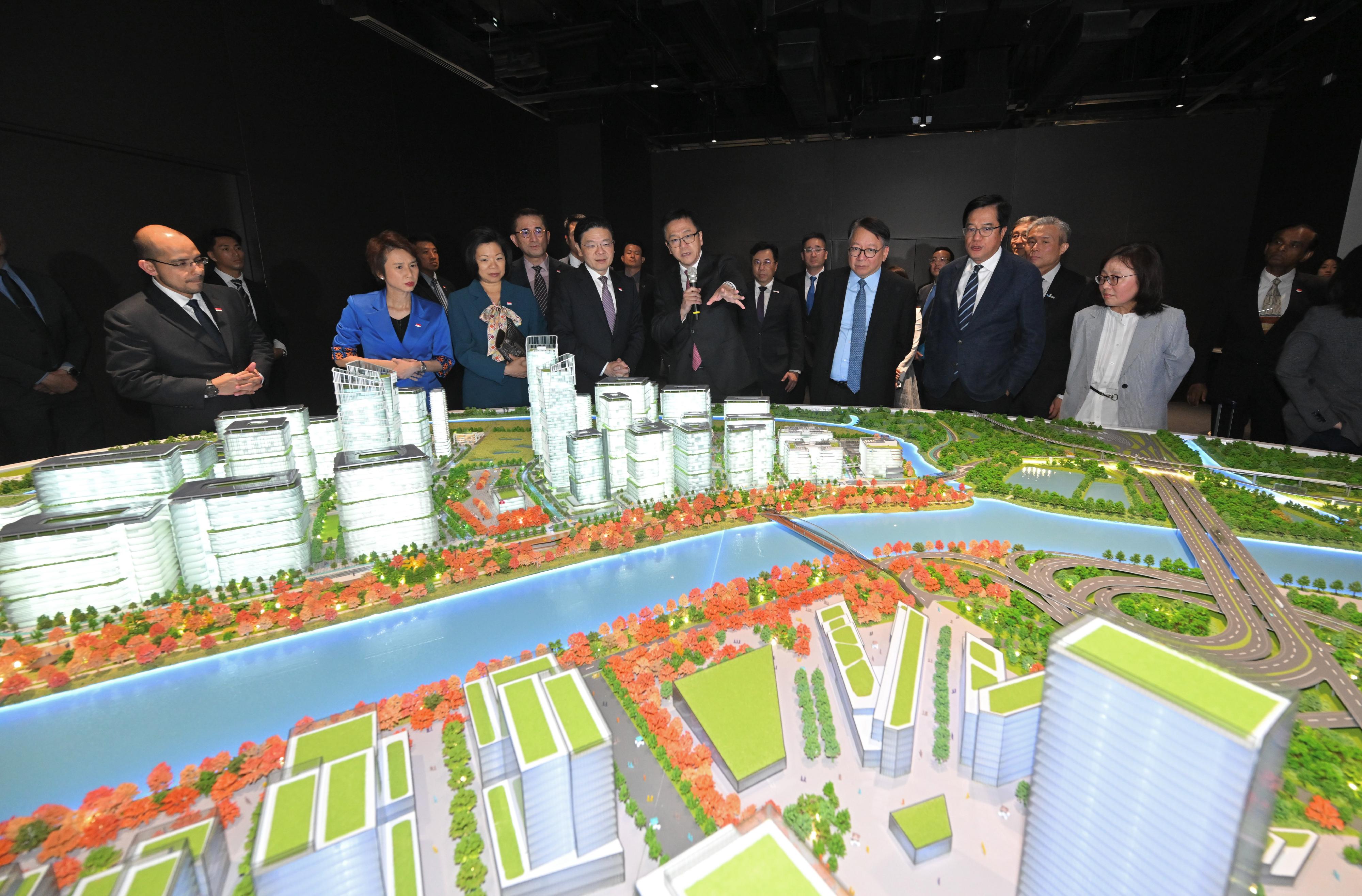 The Prime Minister and Minister for Finance of Singapore, Mr Lawrence Wong, visited the Hong Kong Park of the Hetao Shenzhen-Hong Kong Science and Technology Innovation Co-operation Zone (the Hong Kong Park in the Loop) in the Northern Metropolis today (March 27). Photo shows Mr Wong (front row, fourth left) being briefed by the Secretary for Innovation, Technology and Industry, Professor Sun Dong (front row, fourth right) on the Hong Kong Park in the Loop.