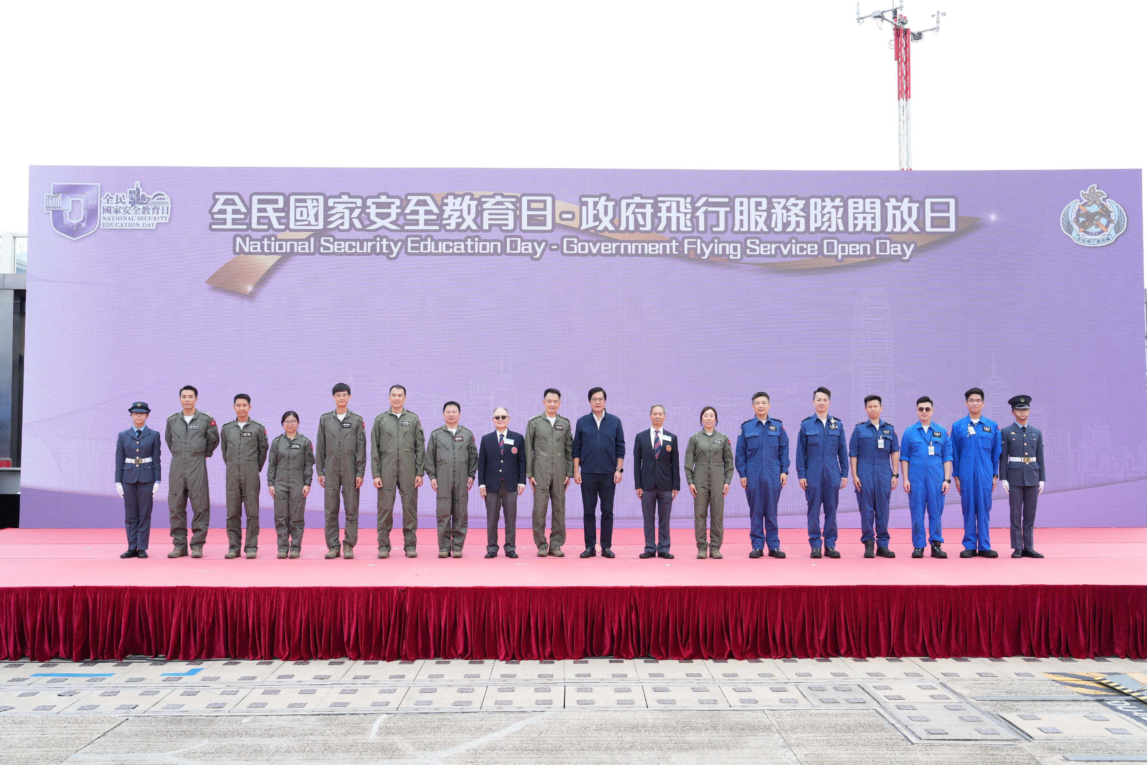 To promote the National Security Education Day, the Government Flying Service (GFS) held an open day today (March 29) at the GFS Kai Tak Division. Photo shows the Deputy Financial Secretary, Mr Michael Wong (ninth right), the Controller of GFS, Captain Eddie Liu (ninth left), the Chairman of the Executive Board of the Hong Kong Air Cadet Corps (HKACC), Mr Edwin Lau (eighth left), the Commanding Officer of the HKACC, Mr Chan Man-lang (eighth right), and representatives of the GFS and HKACC.