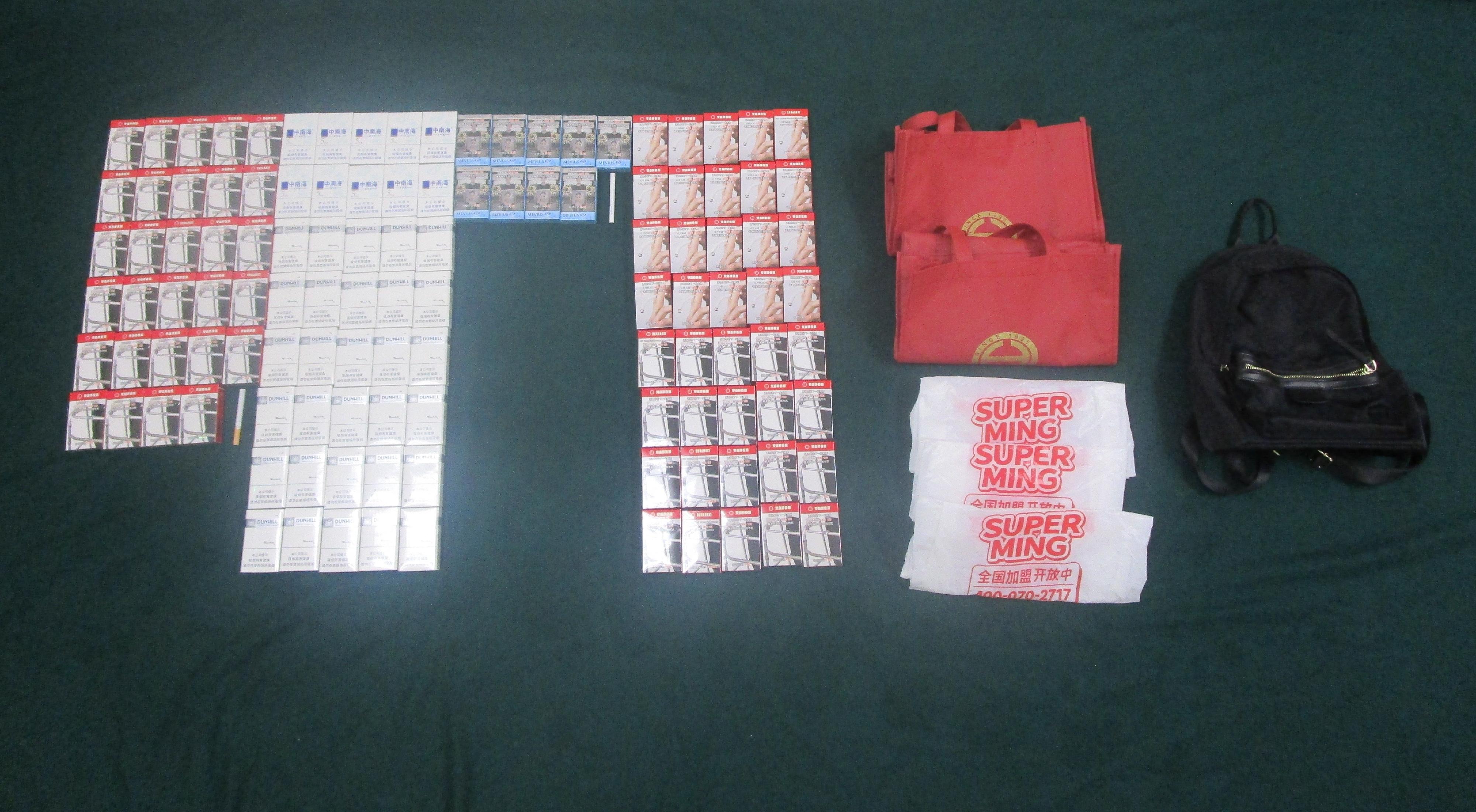 Four incoming passengers were sentenced to three months' imprisonment and a fine of $4,000, two months' imprisonment with a fine of $2,000 and two months&rsquo; imprisonment with a fine of $5,000 respectively by the Fanling Magistrates' Courts today (March 30) for possessing or importing duty-not-paid cigarettes and failing to declare them to Customs officers, in contravention of Dutiable Commodities Ordinance. Photo shows the duty-not-paid cigarettes seized from the personal baggage of a 48-year-old incoming male passenger and an accompanying 53-year-old incoming female passenger.
