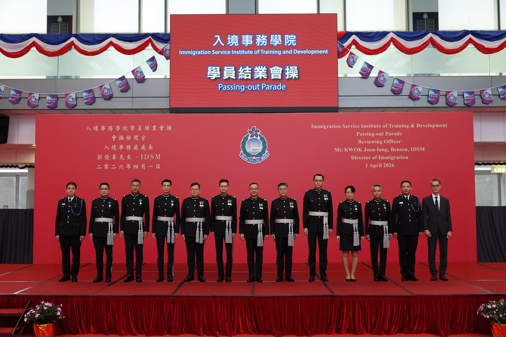 The Immigration Service Institute of Training and Development Passing-out Parade was held today (April 1).  Photo shows the Director of Immigration, Mr Benson Kwok (centre), with directorate officers of the Immigration Department after the parade.