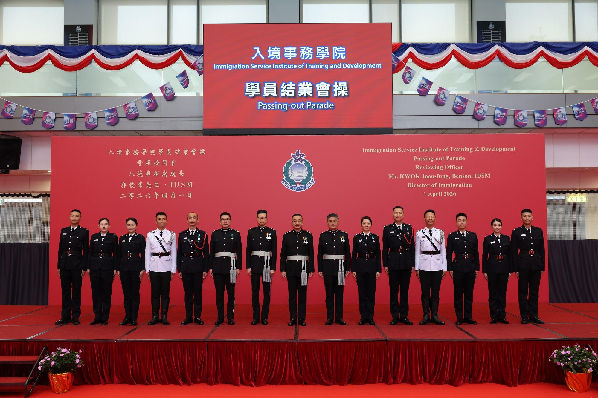 The Director of Immigration, Mr Benson Kwok (centre), is pictured with the graduates who received the "Best Recruit Shields" after the Immigration Service Institute of Training and Development Passing-out Parade today (April 1).