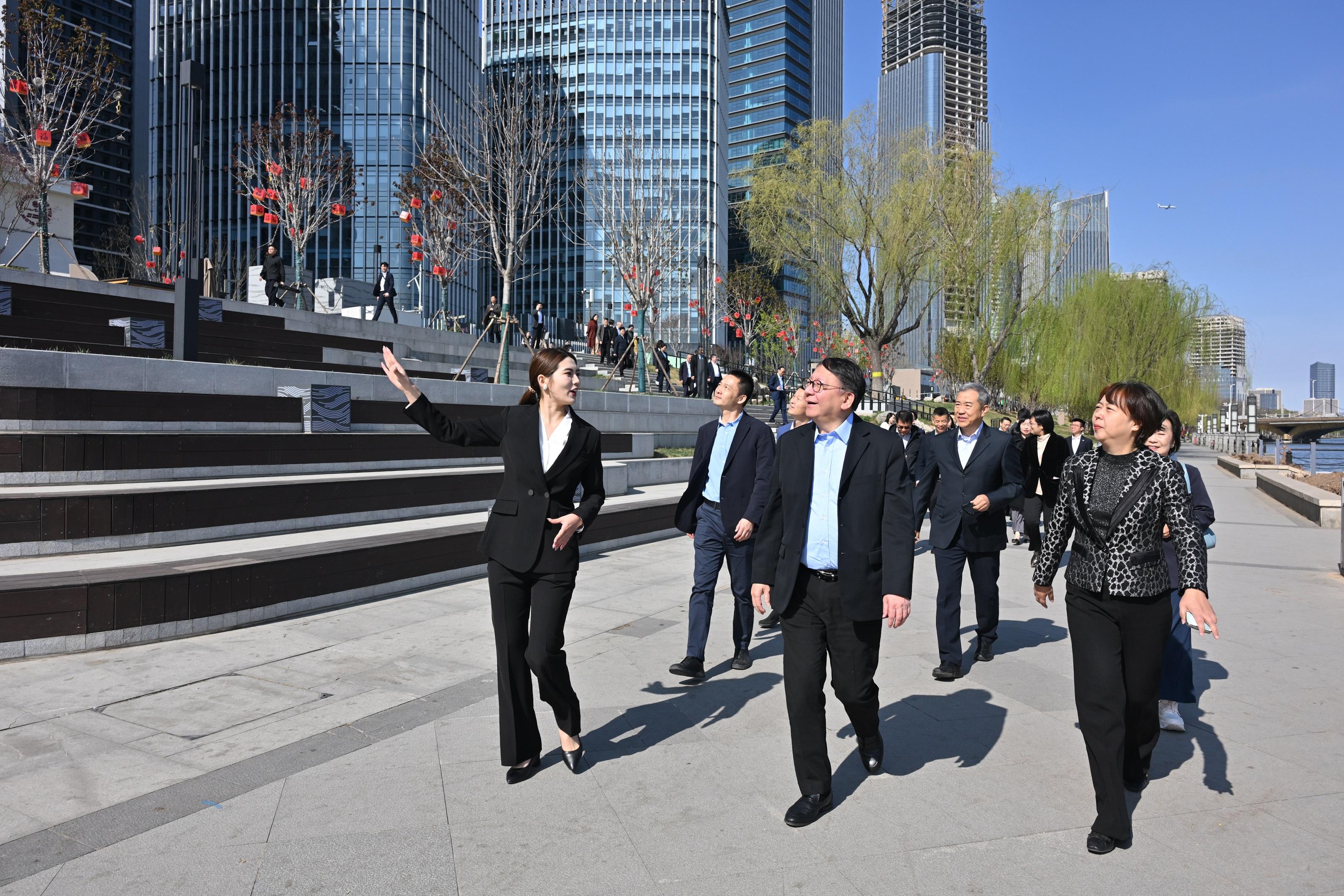 The Chief Secretary for Administration, Mr Chan Kwok-ki, today (April 1) led the delegation of the Working Group on Planning and Construction of the University Town under the Committee on Development of the Northern Metropolis to continue its visit to the Beijing Municipal Administrative Center and Xiong'an New Area in Hebei. Photo shows Mr Chan (front row, centre) and the delegation, accompanied by  the Director of Bureau IV of the Hong Kong and Macao Work Office of the Communist Party of China Central Committee and the Hong Kong and Macao Affairs Office of the State Council, Mr Chen Wei (back row, first left), visiting the Yunhe Business District of the Beijing Municipal Administrative Center.