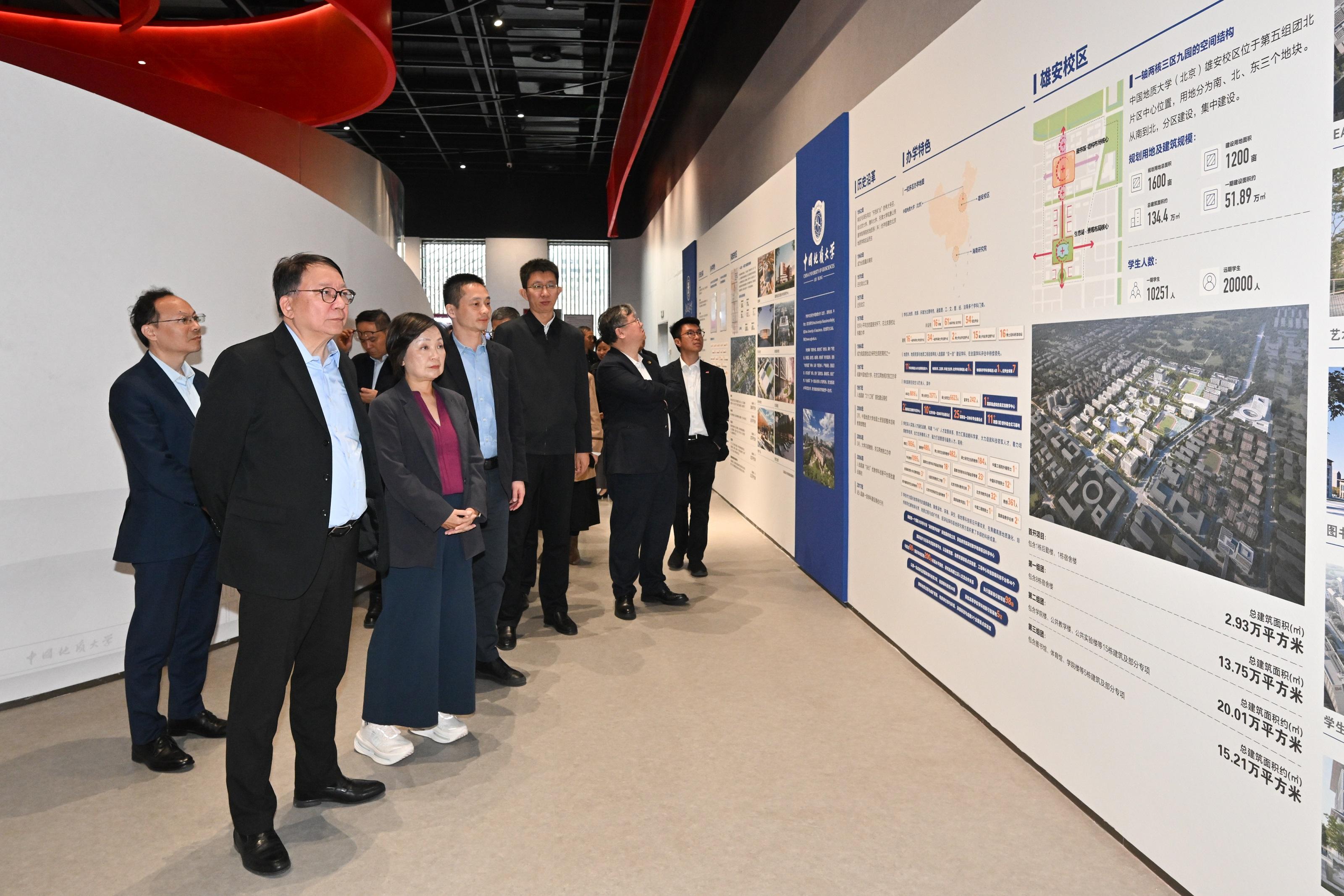 The Chief Secretary for Administration, Mr Chan Kwok-ki, today (April 1) led the delegation of the Working Group on Planning and Construction of the University Town under the Committee on Development of the Northern Metropolis to continue its visit to the Beijing Municipal Administrative Center and Xiong'an New Area in Hebei. Photo shows Mr Chan (second left), the Secretary for Education, Dr Choi Yuk-lin (third left), and the delegation, accompanied by  the Director of Bureau IV of the Hong Kong and Macao Work Office of the Communist Party of China Central Committee and the Hong Kong and Macao Affairs Office of the State Council, Mr Chen Wei (fourth left), visiting the University Town of Fifth Cluster North Collaborative Innovation Exhibition Hall.