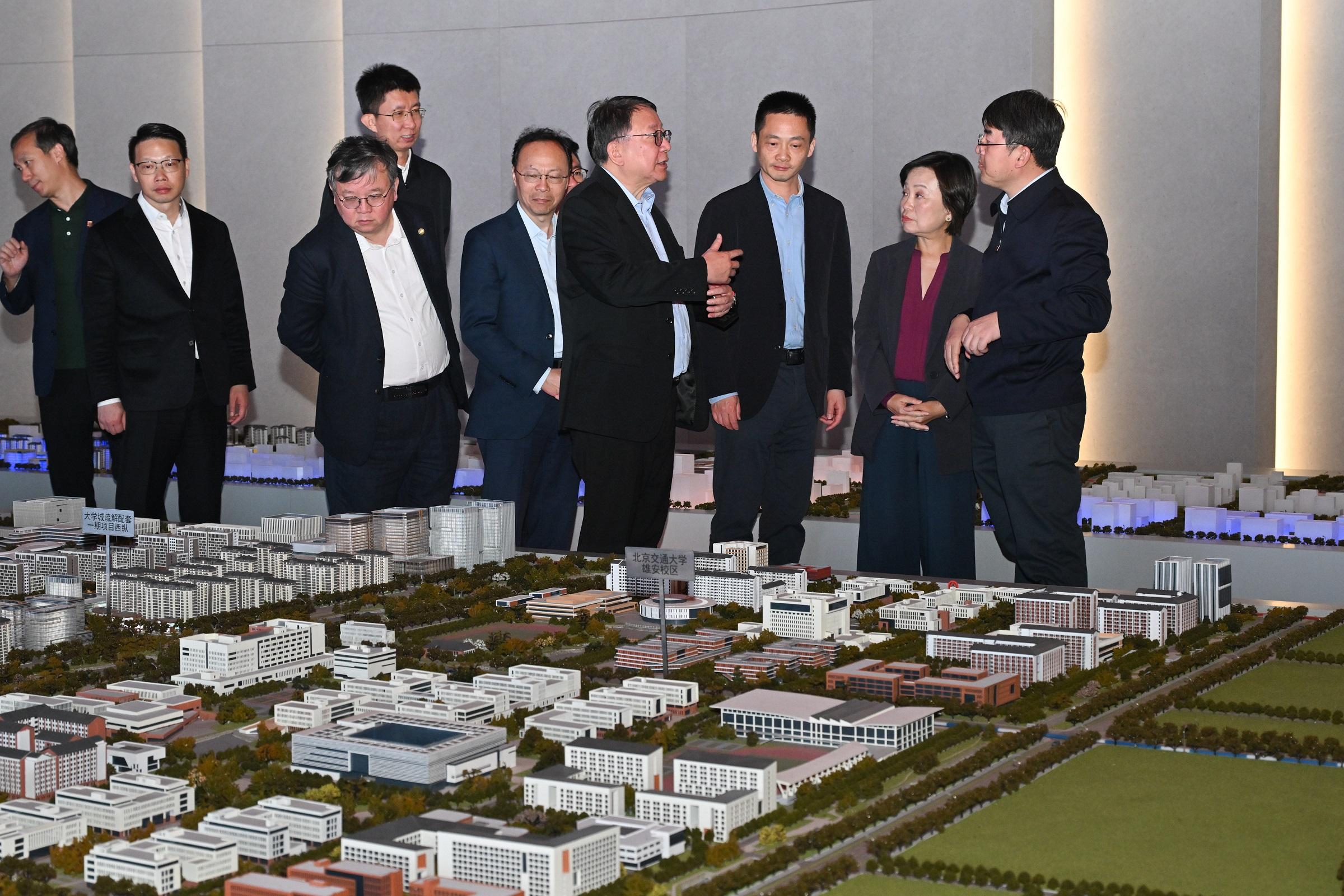 The Chief Secretary for Administration, Mr Chan Kwok-ki, today (April 1) led the delegation of the Working Group on Planning and Construction of the University Town under the Committee on Development of the Northern Metropolis to continue its visit to the Beijing Municipal Administrative Center and Xiong'an New Area in Hebei. Photo shows Mr Chan (fourth right), the Secretary for Education, Dr Choi Yuk-lin (second right), and the delegation, accompanied by  the Director of Bureau IV of the Hong Kong and Macao Work Office of the Communist Party of China Central Committee and the Hong Kong and Macao Affairs Office of the State Council, Mr Chen Wei (third right), visiting the University Town of Fifth Cluster North Collaborative Innovation Exhibition Hall.