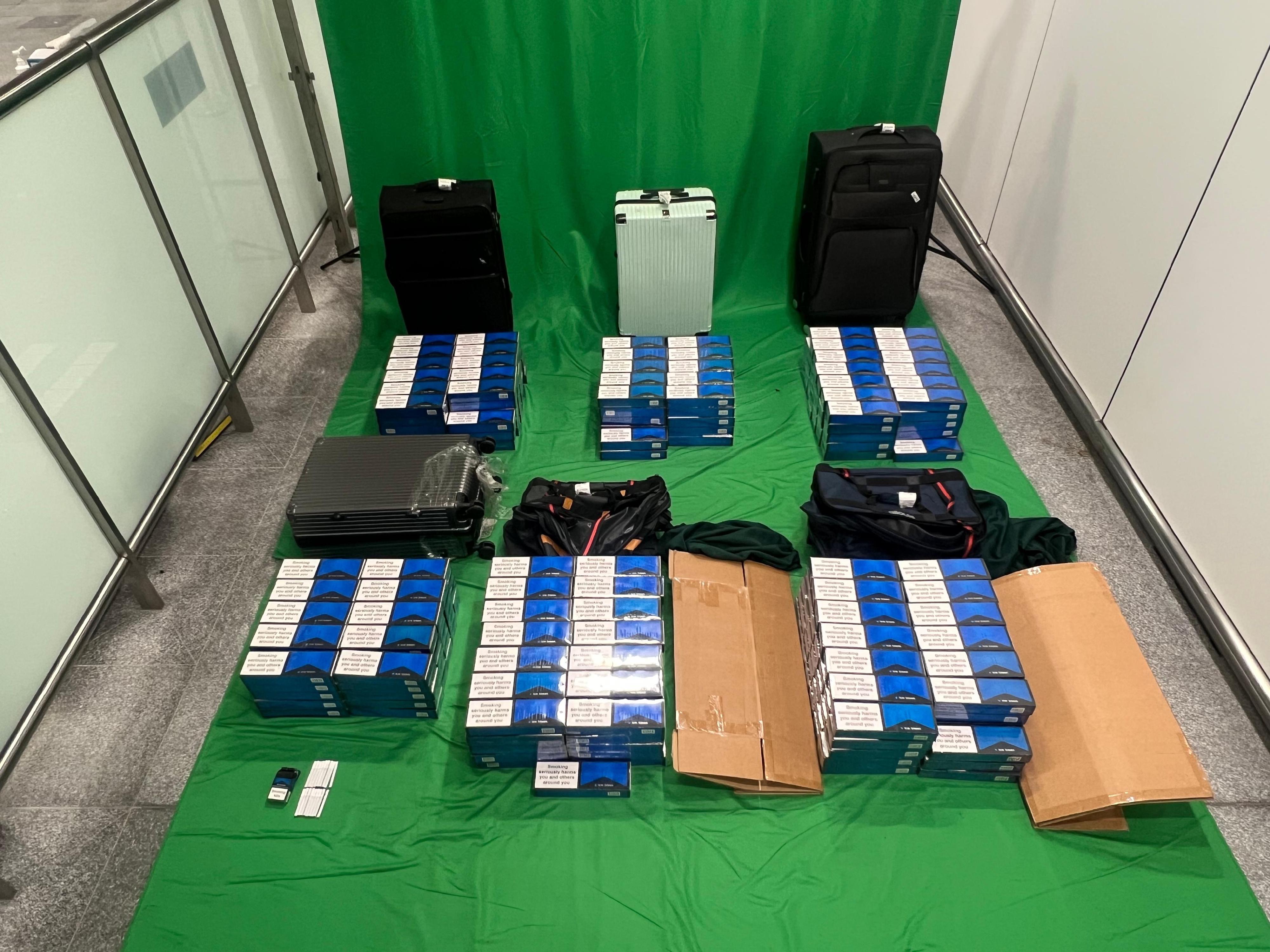 Three incoming passengers were sentenced to between five to seven months' imprisonment and fined $500 to $1,000 by the West Kowloon Magistrates' Courts today (April 2) for importing and possessing duty-not-paid cigarettes and failing to declare them to Customs officers, in contravention of the Dutiable Commodities Ordinance. Photo shows the duty-not-paid cigarettes seized from the personal baggage of two incoming male passengers, aged 32 and 38.