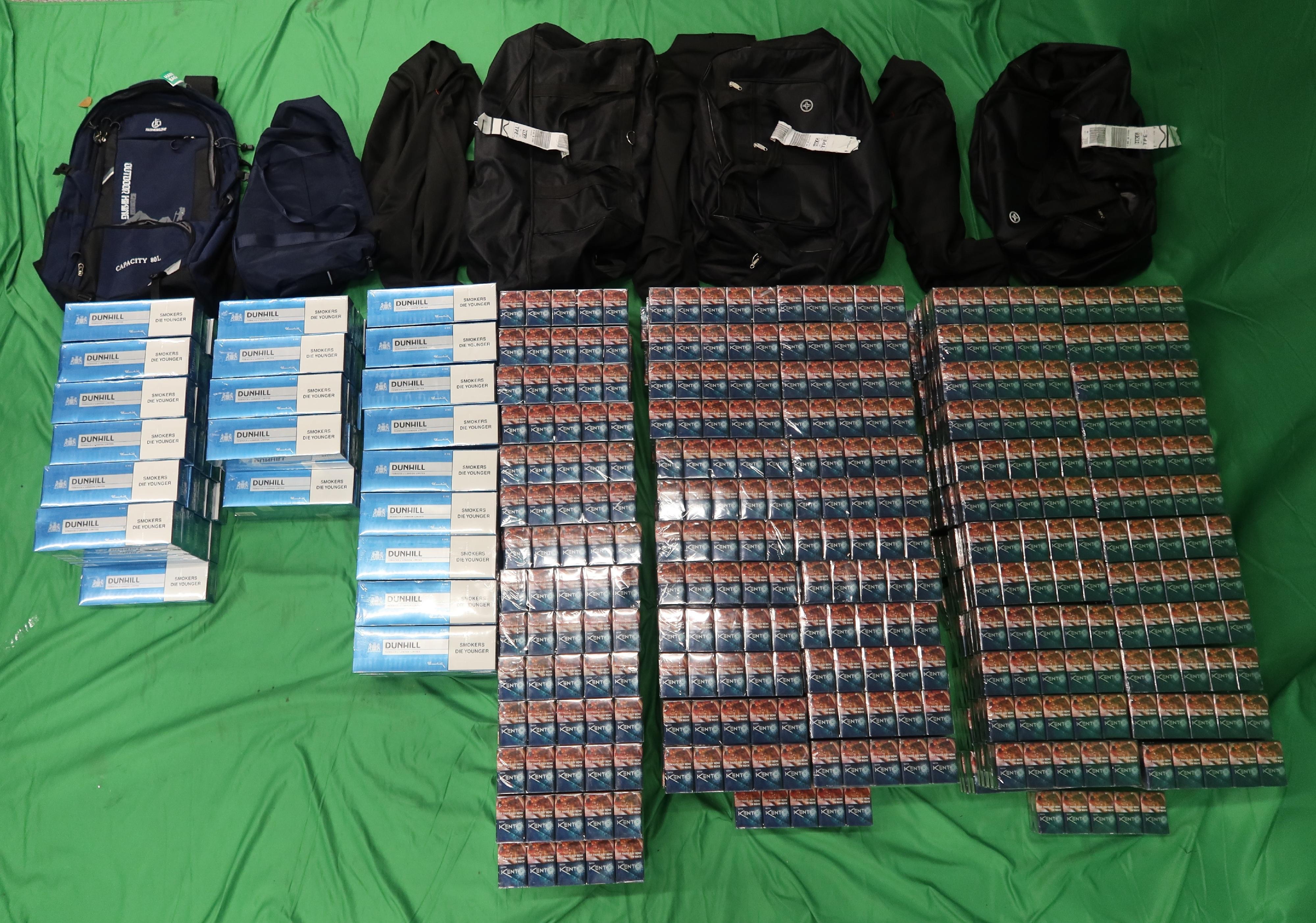 Three incoming passengers were sentenced to between five to seven months' imprisonment and fined $500 to $1,000 by the West Kowloon Magistrates' Courts today (April 2) for importing and possessing duty-not-paid cigarettes and failing to declare them to Customs officers, in contravention of the Dutiable Commodities Ordinance. Photo shows the duty-not-paid cigarettes seized from the personal baggage of a 33-year-old incoming male passenger.