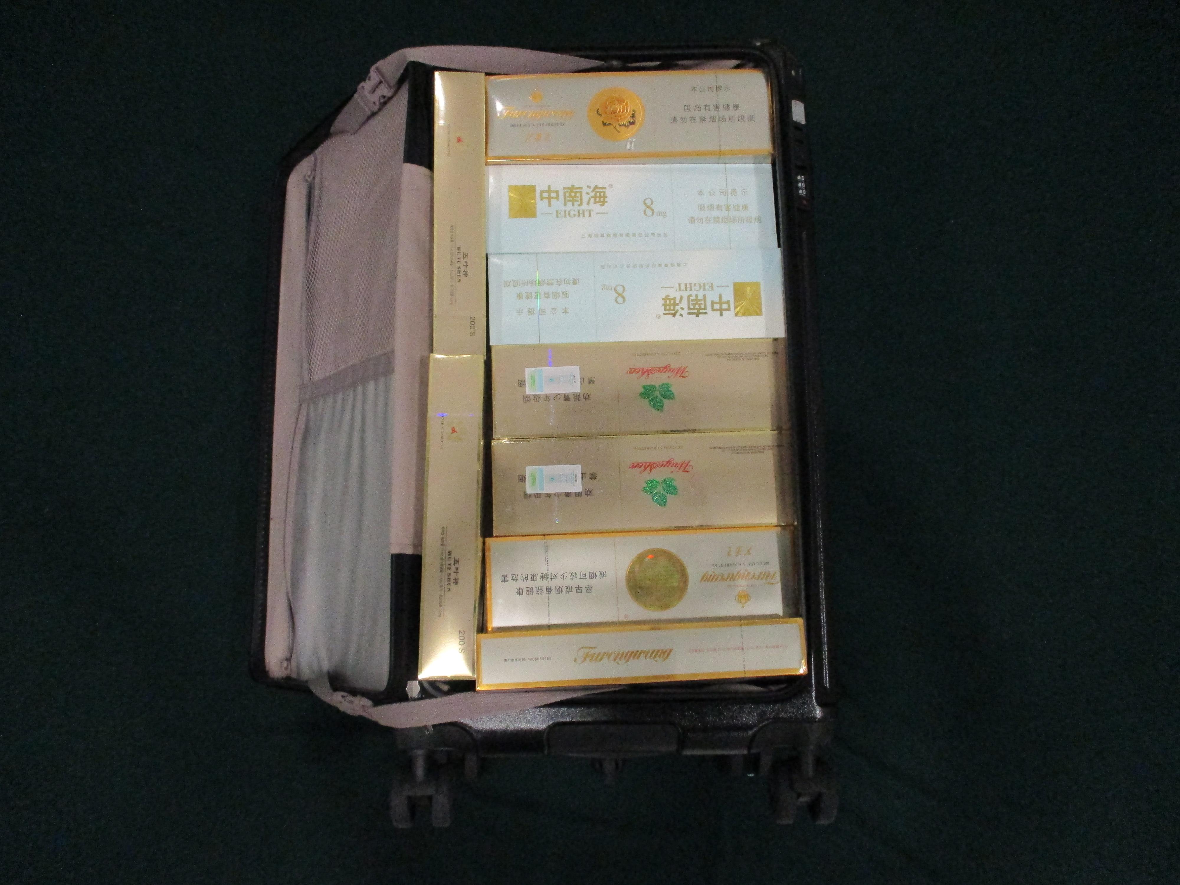 Two incoming passengers were sentenced to three months' imprisonment with a fine of $1,800 and two months' imprisonment with a fine of $1,800 respectively by the Fanling Magistrates' Courts today (April 8) for possessing duty-not-paid cigarettes and failing to declare them to Customs officers, in contravention of Dutiable Commodities Ordinance. Photo shows the duty-not-paid cigarettes seized from the personal baggage of a 61-year-old incoming female passenger.