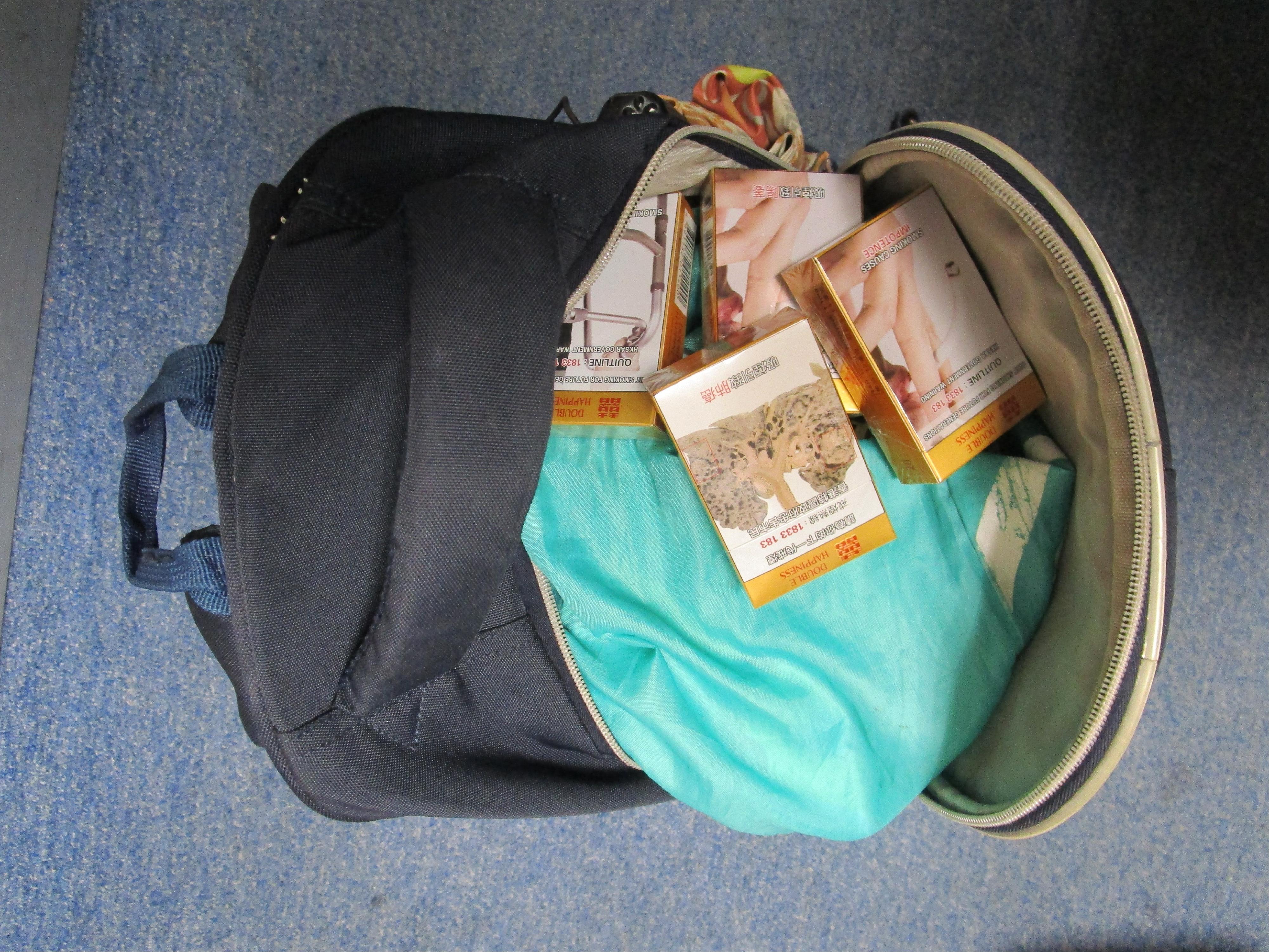 Two incoming passengers were sentenced to six weeks' imprisonment with a fine of $4,000, and four weeks' imprisonment with a fine of $3,000, respectively, by the Fanling Magistrates' Courts today (April 9) for possessing duty-not-paid tobacco and failing to declare it to Customs officers, in contravention of the Dutiable Commodities Ordinance. Photo shows the duty-not-paid cigarettes seized from the personal baggage of a 64-year-old incoming female passenger.