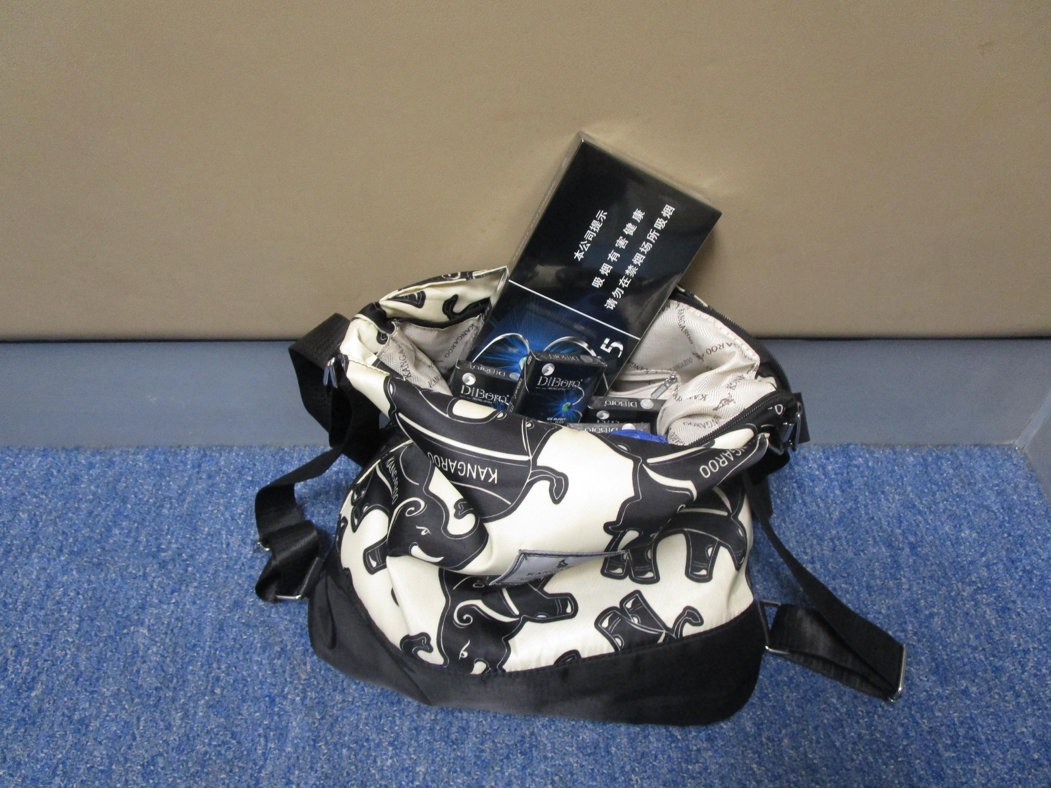 Two incoming passengers were sentenced to six weeks' imprisonment with a fine of $4,000, and four weeks' imprisonment with a fine of $3,000, respectively, by the Fanling Magistrates' Courts today (April 9) for possessing duty-not-paid tobacco and failing to declare it to Customs officers, in contravention of the Dutiable Commodities Ordinance. Photo shows the duty-not-paid cigarettes seized from the personal baggage of a 55-year-old incoming female passenger.