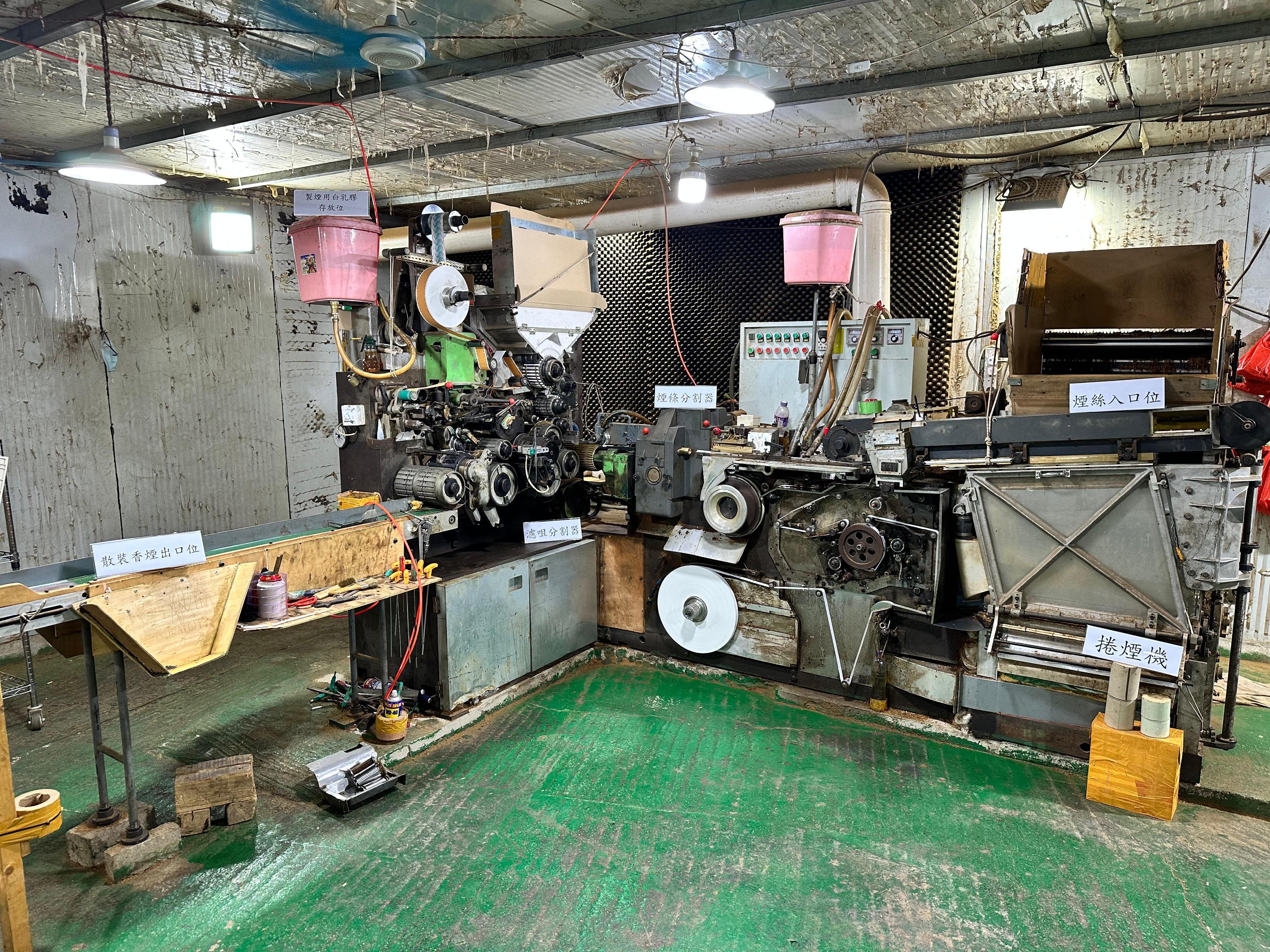 Hong Kong Customs shut down an underground cigarette factory in Fanling yesterday (April 9), and seized about 31.92 tons of suspected duty-not-paid manufactured tobacco and 1.23 million sticks of suspected illicit cigarette. The total estimated market value of all seizure was about $220 million, while the duty potential was about $130 million. Six persons suspected to be connected with the case were arrested. Photo shows the machines for producing and packaging illicit cigarettes seized in the metal hut.