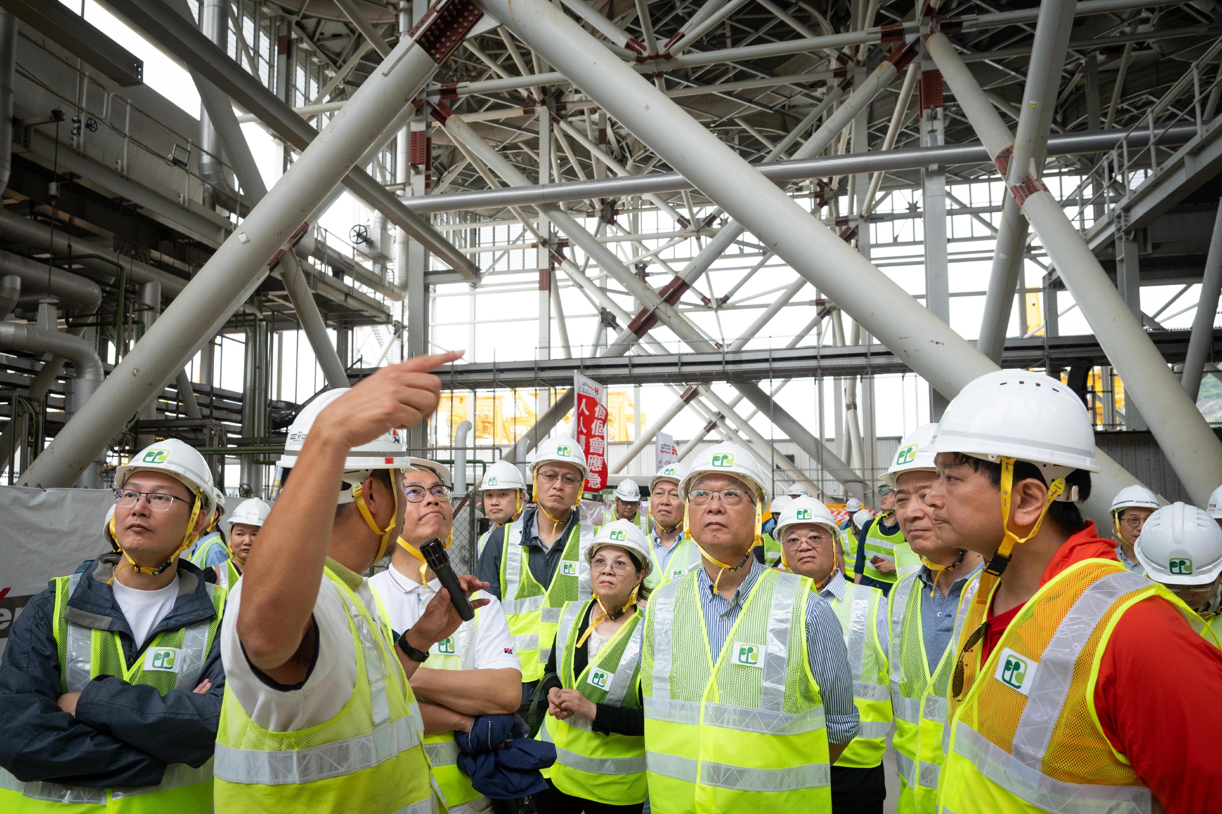The Secretary for Environment and Ecology, Mr Tse Chin-wan, today (April 11) and several members of the Legislative Council (LegCo) inspected Hong Kong's first modern waste-to-energy facility located on an artificial island off Shek Kwu Chau for treating municipal solid waste - Integrated Waste Management Facilities Phase I (I·PARK1). Photo shows Mr Tse (first row, third right); the Permanent Secretary for Environment and Ecology (Environment), Mr Eddie Cheung (third row, first right); the Under Secretary for Environment and Ecology, Miss Diane Wong (second row, second right); the Director of Environmental Protection, Dr Samuel Chui (second row, first right) and LegCo members inspecting the air-cooled condenser in I·PARK1 adopted for cooling high temperature steam after powering the turbine generator.