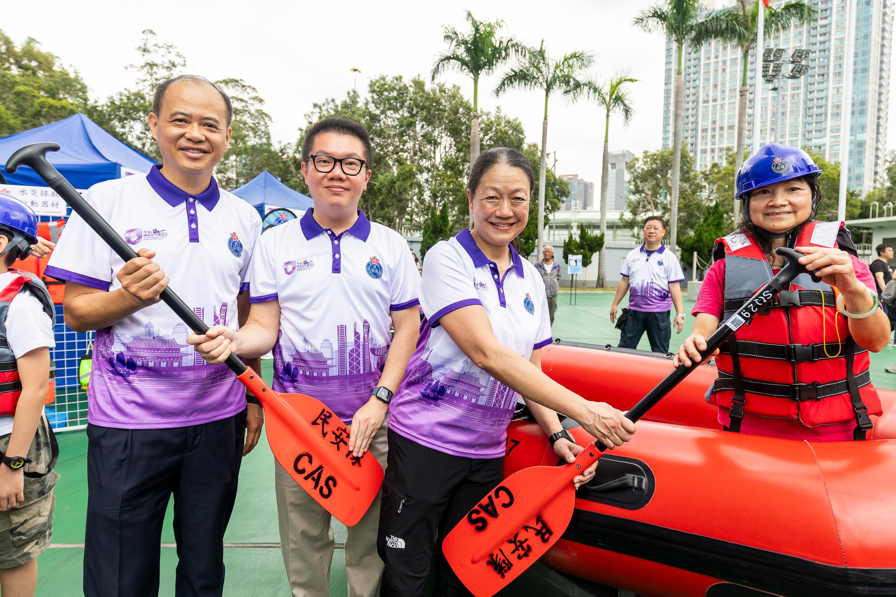 The Civil Aid Service held an open day at its headquarters today (April 11) to promote National Security Education Day. Photo shows the Permanent Secretary for Security, Mrs Apollonia Liu, (third left), touring the game booth.