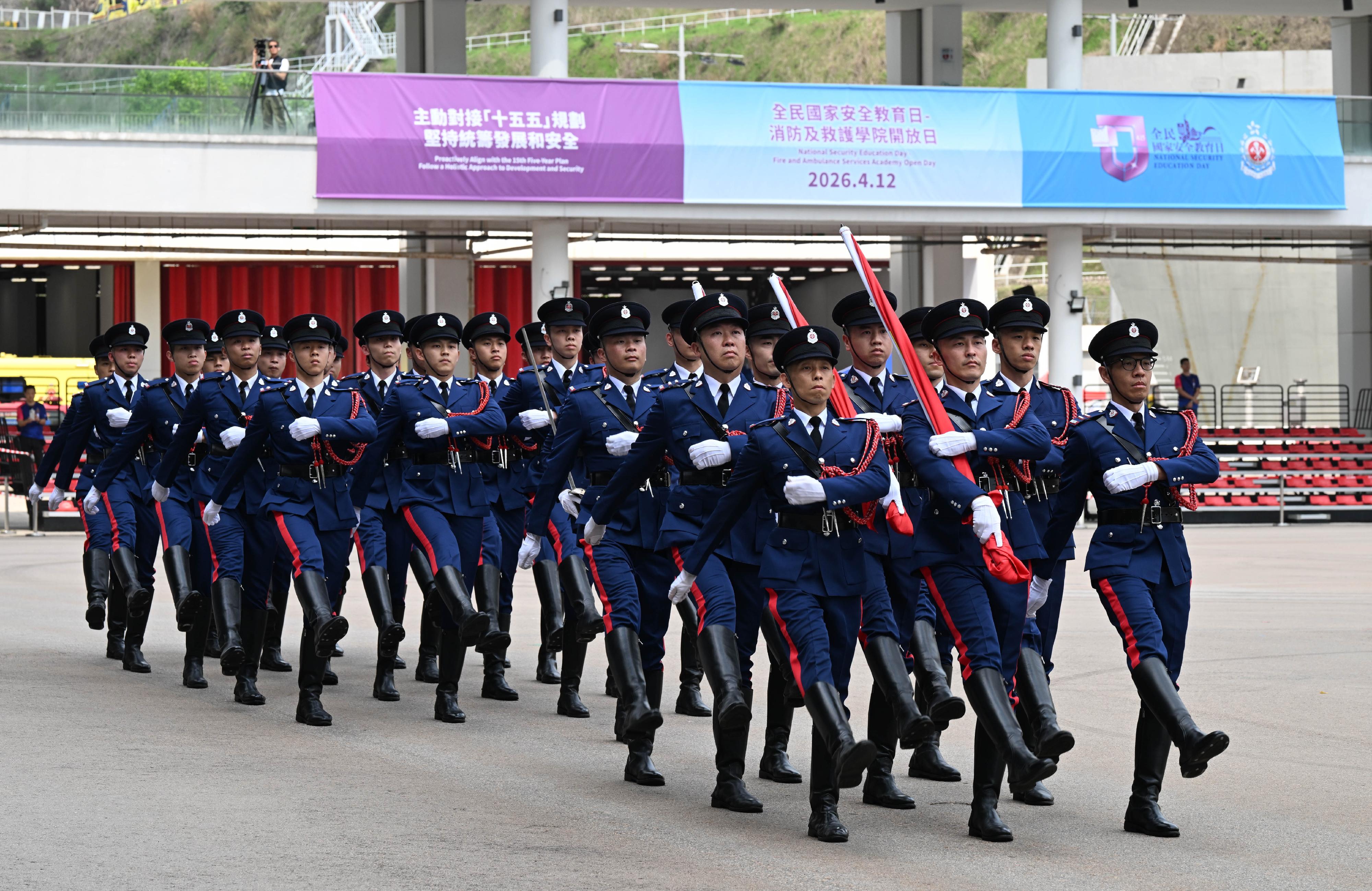 In response to and in support of the 11th National Security Education Day, the Fire Services Department (FSD) held an open day at the Fire and Ambulance Services Academy in Tseung Kwan O today (April 12). Photo shows the FSD's Guard of Honour marching into the venue with Chinese-style foot drill for conducting a flag-raising ceremony.