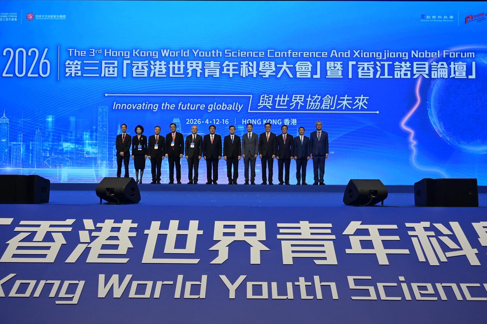 The Chief Executive, Mr John Lee, attended the Opening Ceremony of 3rd Hong Kong World Youth Science Conference and Xiangjiang Nobel Forum 2026 today (April 12). Photo shows Mr Lee (sixth right); Deputy Director of the Liaison Office of the Central People's Government in the Hong Kong Special Administrative Region Mr Zhang Yong (sixth left); Deputy Commissioner of the Office of the Commissioner of the Ministry of Foreign Affairs of the People's Republic of China in the Hong Kong Special Administrative Region Mr Li Yongsheng (fifth left); Director of Bureau IV of the Hong Kong and Macao Work Office of the Communist Party of China Central Committee and the Hong Kong and Macao Affairs Office of the State Council, Mr Chen Wei (fifth right); the Secretary for Innovation, Technology and Industry, Professor Sun Dong (fourth right); the President of the Hong Kong Alumni Association of Beijing Universities, Ms Li Ran (second left), and other guests at the ceremony.