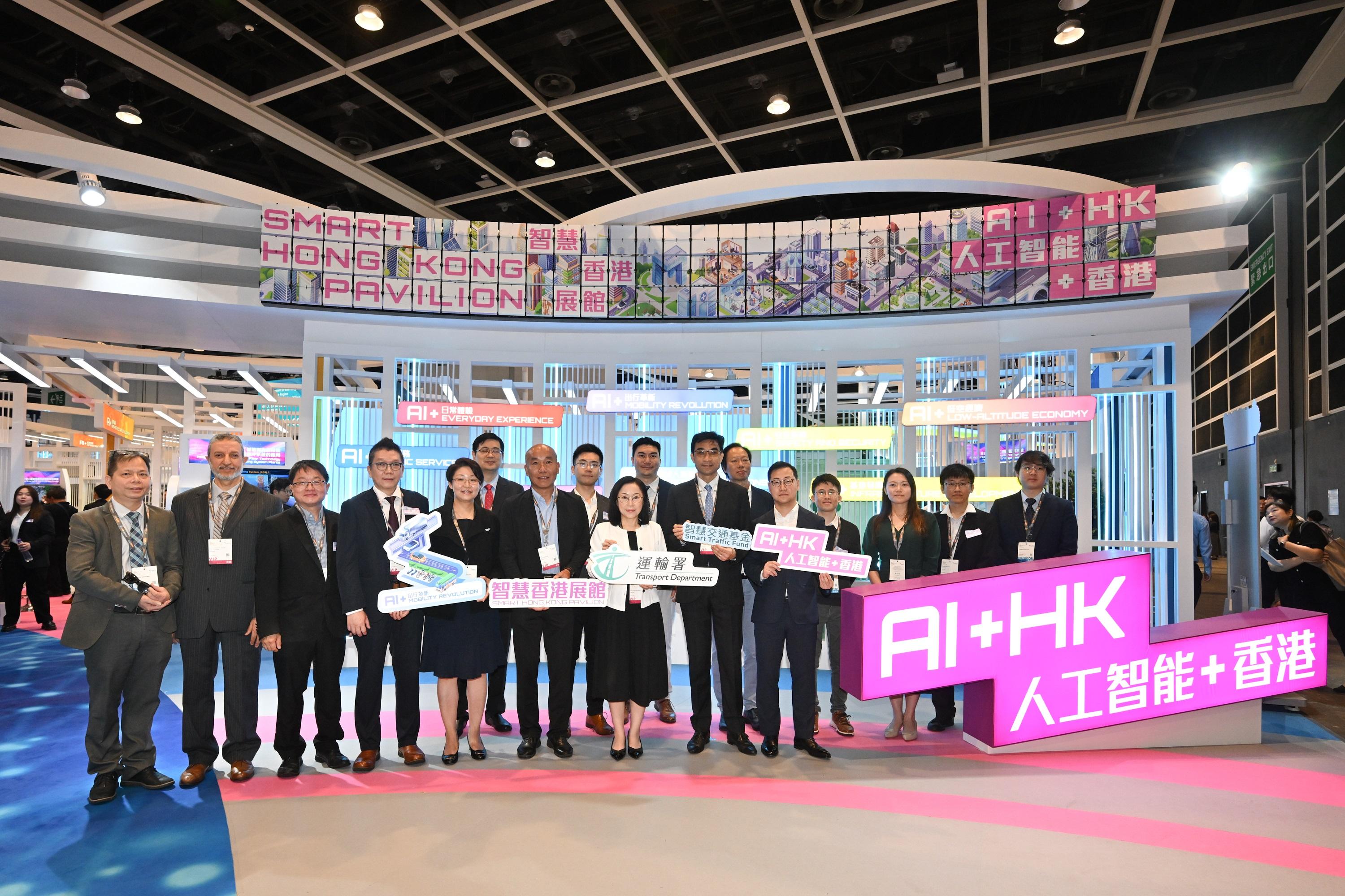 The Commissioner for Transport, Miss Winnie Tse, today (April 13) visited the InnoEX to learn more about the Smart Traffic Fund projects showcased at the Smart Hong Kong Pavilion, and experience the integration of digital technology and artificial intelligence into traffic and transport solutions. Photo shows (front row, from sixth left) the Assistant Commissioner for Transport/Technical Services, Mr Alex Au; Miss Tse; the Deputy Commissioner for Transport/Planning and Technical Services and Chairperson of the Management Committee on Smart Traffic Fund, Mr Patrick Ho; the Chief Engineer/Smart Mobility of the Transport Department, Mr George Fong; and representatives of the Fund Secretariat and projects showcased.