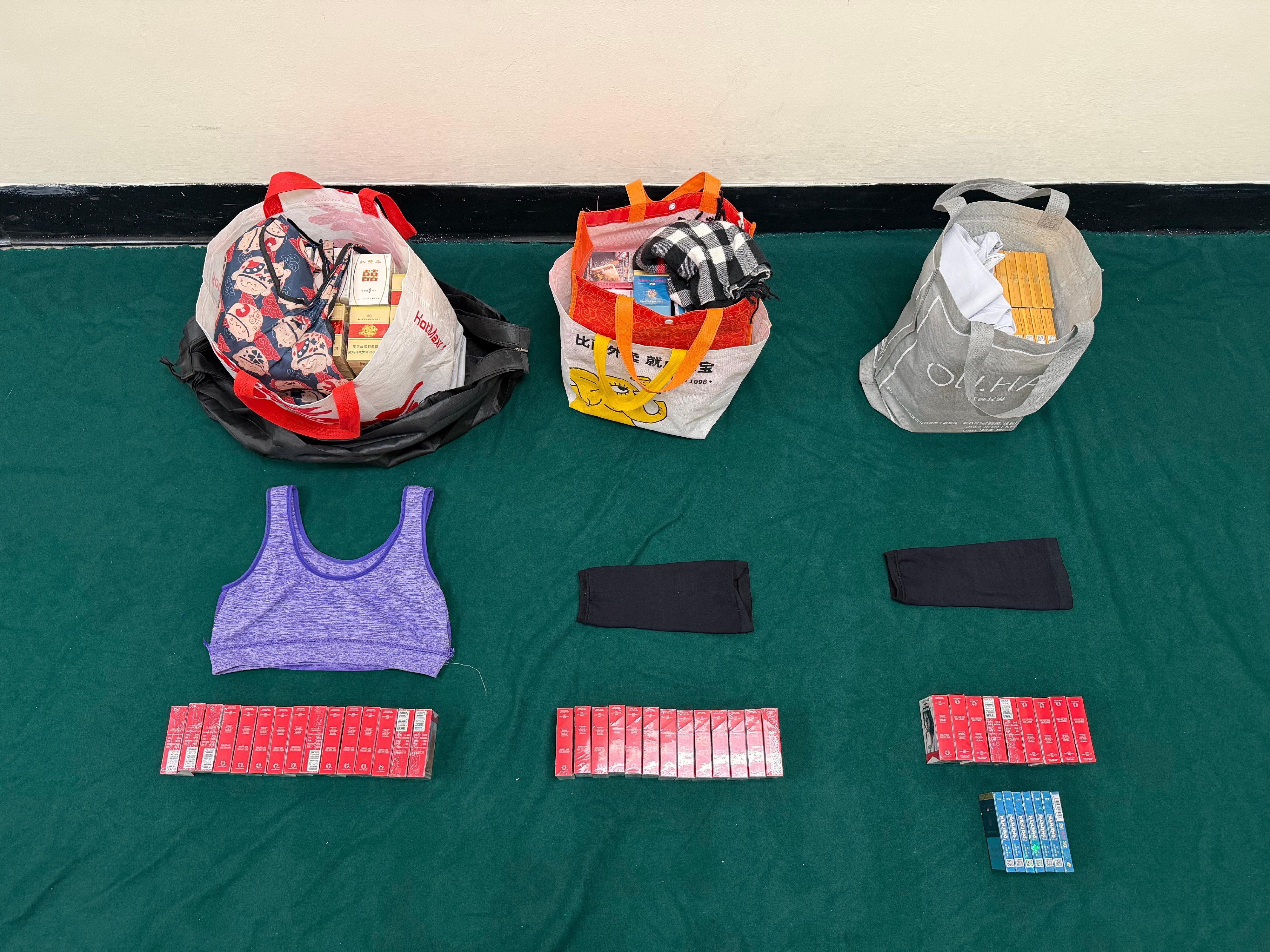 An incoming passenger was sentenced to a total of six months' imprisonment with a fine of $6,000 by the Fanling Magistrates' Courts today (April 13) for possessing duty-not-paid cigarettes and failing to declare them to Customs officers in contravention of the Dutiable Commodities Ordinance. Photo shows the duty-not-paid cigarettes seized.