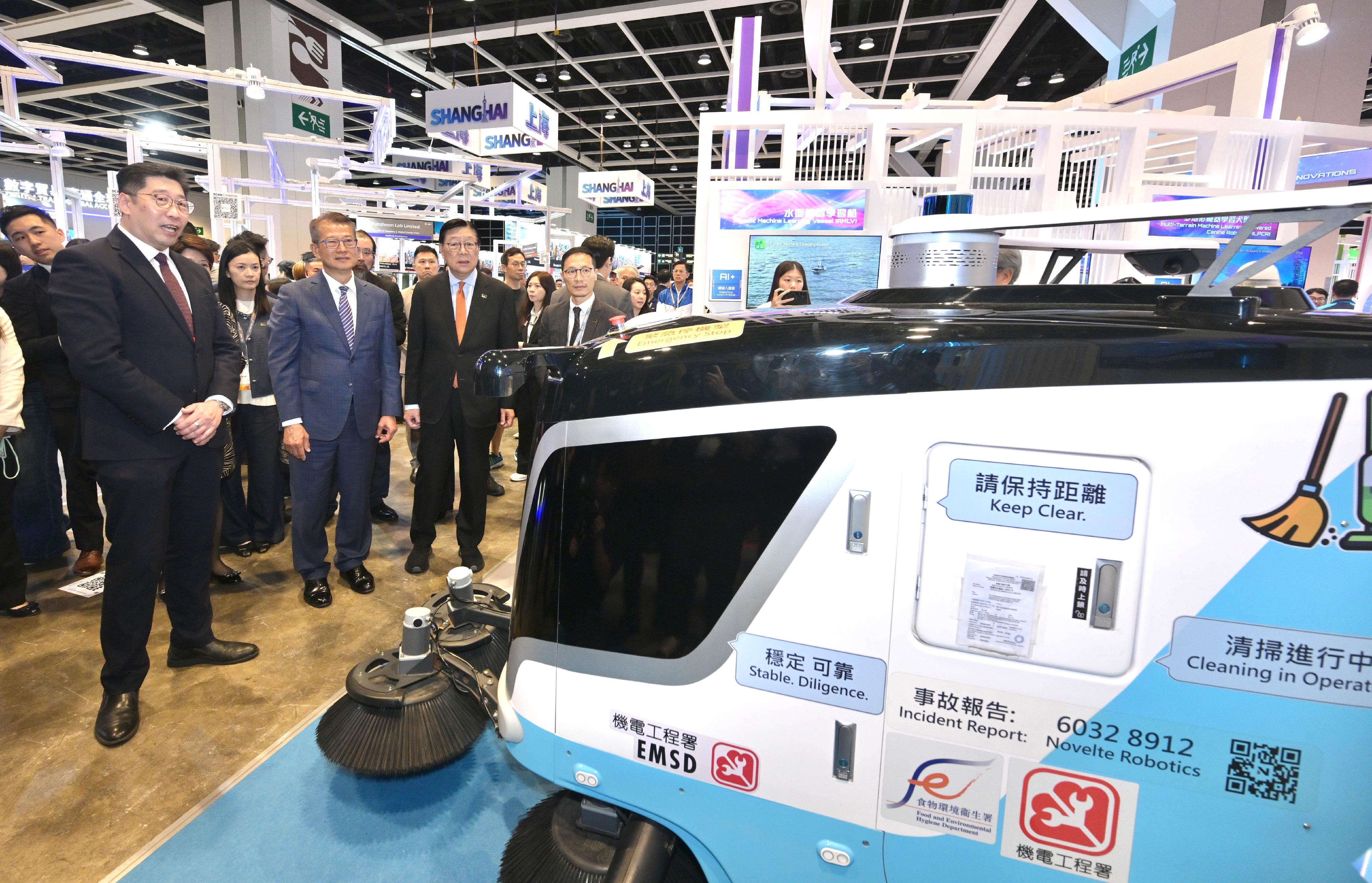 The Innovation, Technology and Industry Bureau and the Hong Kong Trade Development Council are organising the fourth edition of the InnoEX at the Hong Kong Convention and Exhibition Centre for four consecutive days starting yesterday (April 13). Photo shows the Financial Secretary, Mr Paul Chan (second left), visiting the Smart Hong Kong Pavilion at the InnoEX yesterday and being briefed by a representative of the Food and Environmental Hygiene Department. Looking on is the Acting Commissioner for Digital Policy, Mr Daniel Cheung (first left).