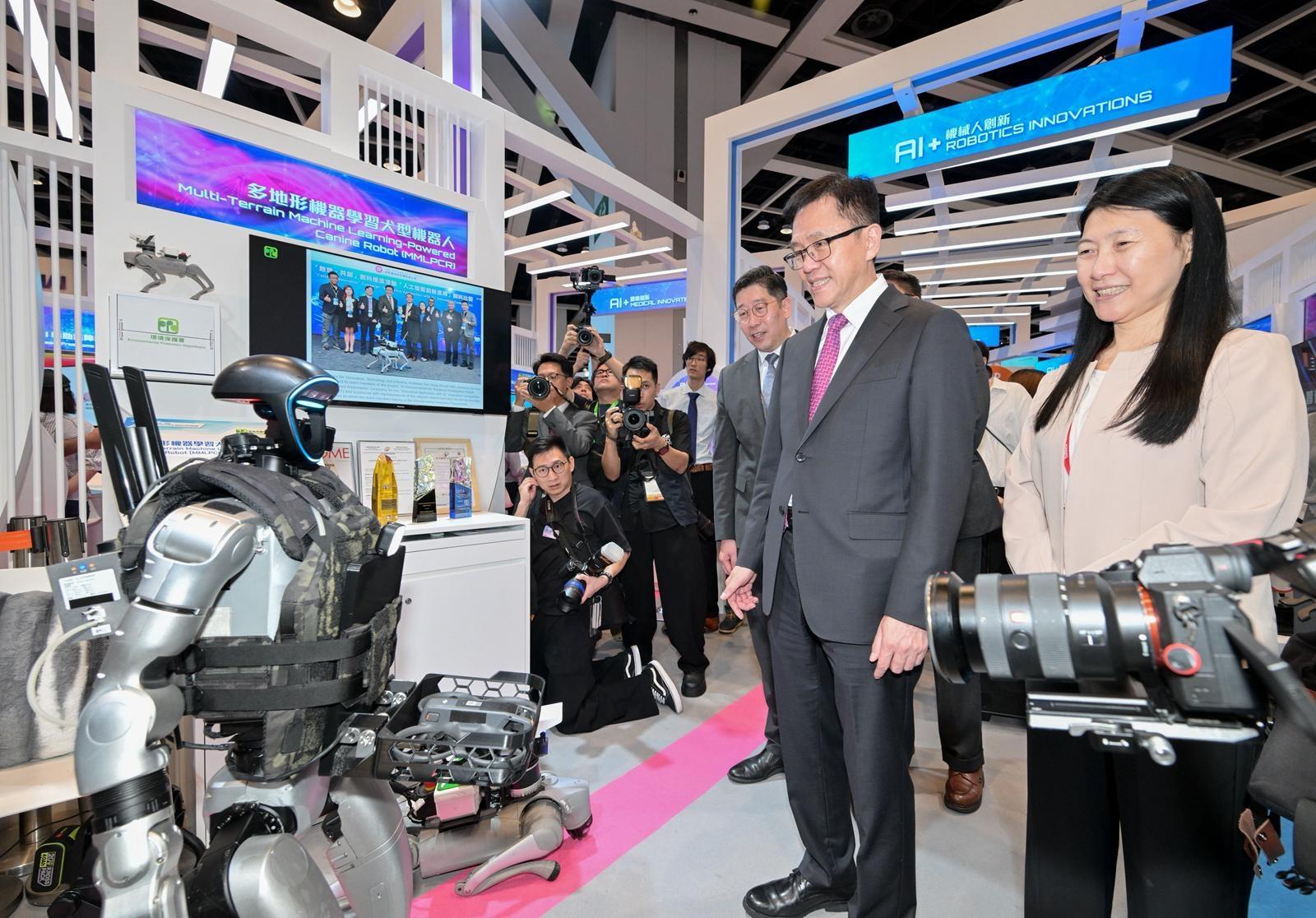 The Innovation, Technology and Industry Bureau and the Hong Kong Trade Development Council are organising the fourth edition of the InnoEX at the Hong Kong Convention and Exhibition Centre for four consecutive days starting yesterday (April 13). Photo shows the Secretary for Innovation, Technology and Industry, Professor Sun Dong (centre) learning about the innovation and technology solution showcased by the Environmental Protection Department at the Smart Hong Kong Pavilion of the InnoEX today (April 14). Looking on are the Acting Commissioner for Digital Policy, Mr Daniel Cheung (left); and the Acting Deputy Commissioner (Digital Infrastructure), Ms Cari Wu (right).