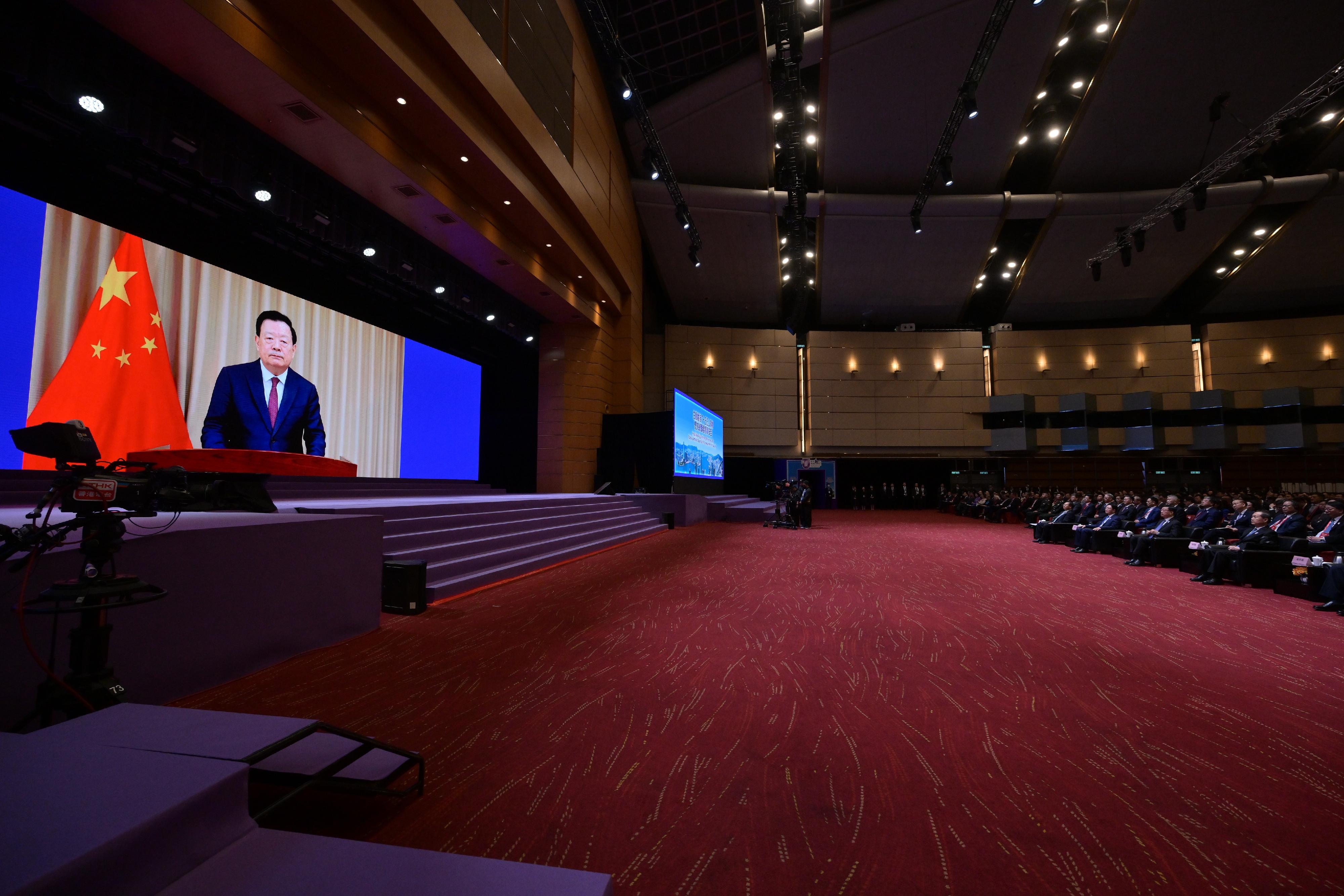 The Chief Executive and Chairman of the Committee for Safeguarding National Security of the Hong Kong Special Administrative Region, Mr John Lee, attended the National Security Education Day Opening Ceremony today (April 15). Photo shows Mr Lee (first row, second right) listening to the Director of the Hong Kong and Macao Work Office of the Communist Party of China Central Committee and the Hong Kong and Macao Affairs Office of the State Council, Mr Xia Baolong (on screen), delivering a speech via videoconferencing.