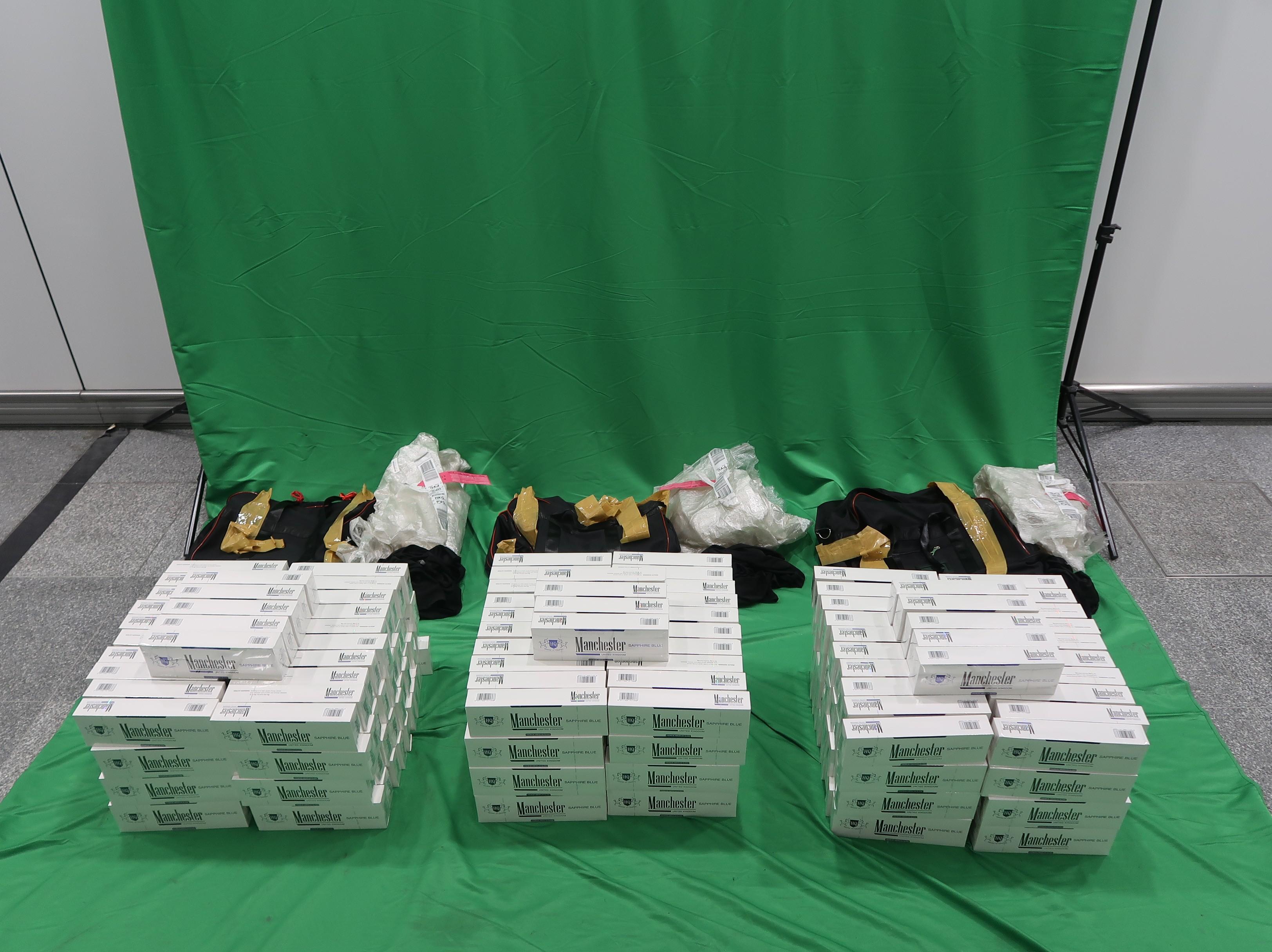 Eight incoming passengers were sentenced between eight to twelve months' imprisonment and fined $2,000 by the West Kowloon Magistrates' Courts today (April 18) for importing and dealing with duty-not-paid cigarettes and failing to declare them to Customs officers, in contravention of the Dutiable Commodities Ordinance (DCO).  Photo shows the duty-not-paid cigarettes seized from the personal baggages of two of the eight incoming passengers. 