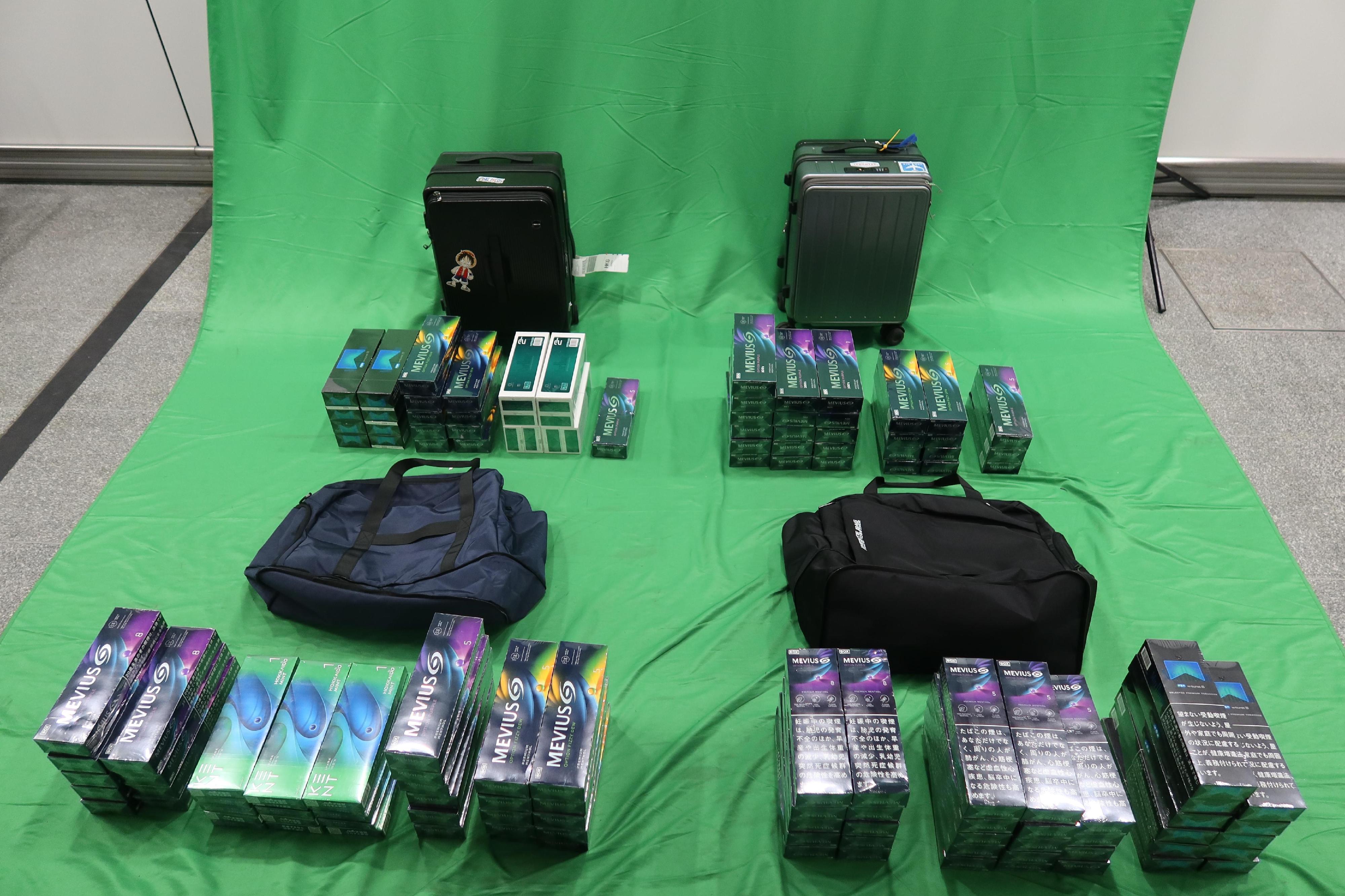 Eight incoming passengers were sentenced between eight to twelve months' imprisonment and fined $2,000 by the West Kowloon Magistrates' Courts today (April 18) for importing and dealing with duty-not-paid cigarettes and failing to declare them to Customs officers, in contravention of the Dutiable Commodities Ordinance (DCO).  Photo shows the duty-not-paid cigarettes seized from the personal baggages of two of the eight incoming passengers. 