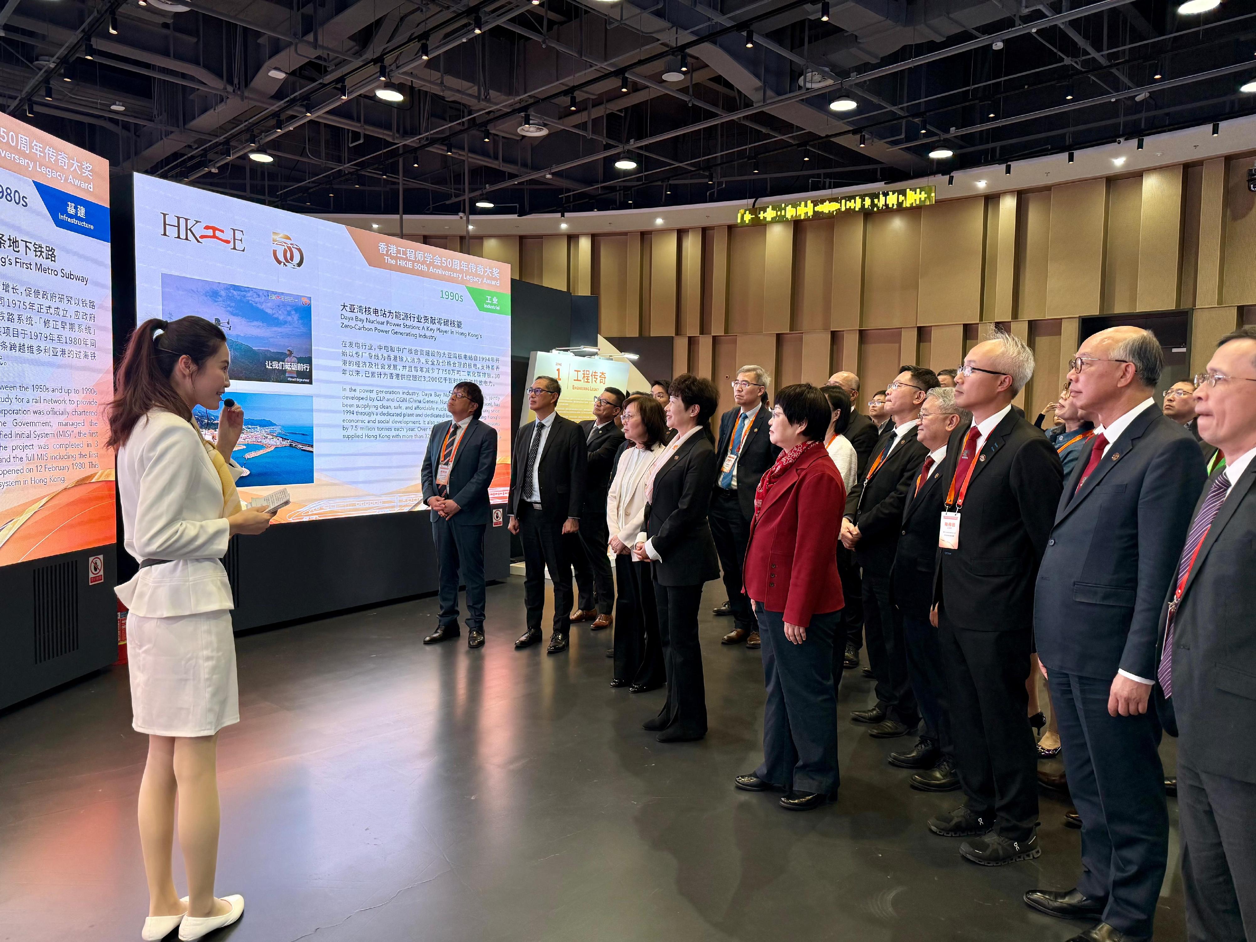 The Secretary for Development, Ms Bernadette Linn, today (April 20) attended the "Hong Kong Engineering Legacy Exhibition@Capital" organised by the Hong Kong Institution of Engineers in celebration of its 50th anniversary in Beijing. Photo shows Ms Linn (front row, third left); the Permanent Secretary for Development (Works), Mr Ricky Lau (front row, second left); and Deputy Secretary for Development (Works) Mr Tony Ho (front row, first left) touring the exhibition.