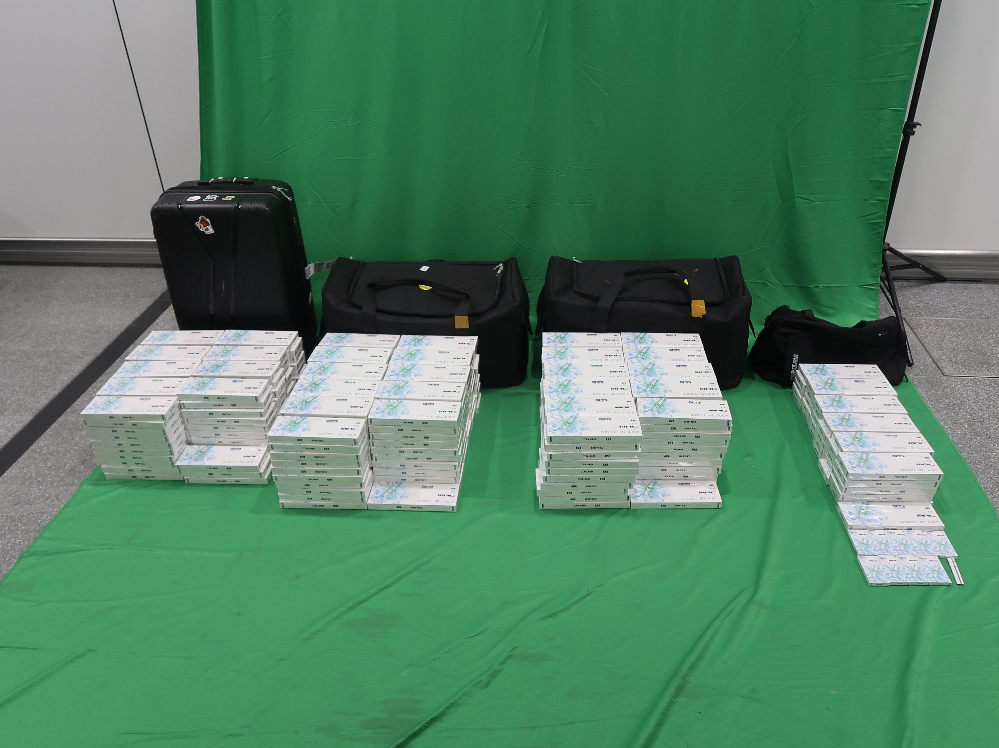 Three incoming passengers were sentenced to seven to eight months' imprisonment and fined $1,000 each by the West Kowloon Magistrates' Courts today (April 20) for importing and possessing duty-not-paid cigarettes and failing to declare them to Customs officers, in contravention of the Dutiable Commodities Ordinance. Photo shows the duty-not-paid cigarettes seized from the personal baggage of a 30-year-old incoming male passenger at Hong Kong International Airport.