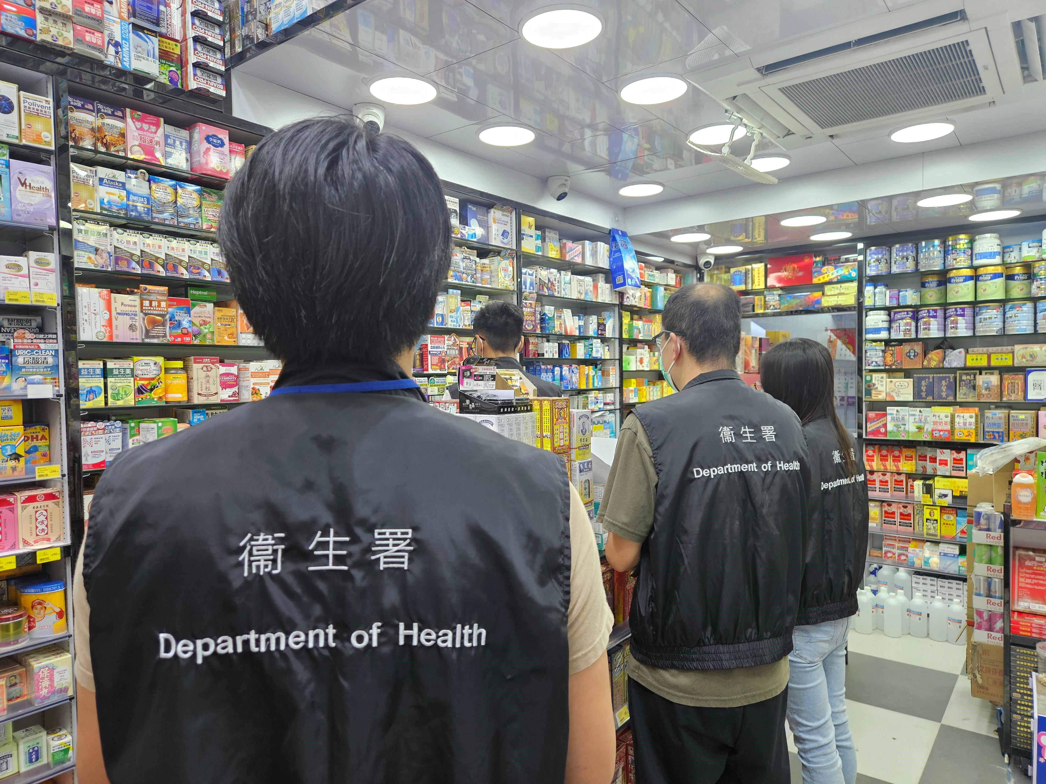 The Department of Health (DH) has stepped up inspection and enforcement efforts across Hong Kong in recent days, arresting five men suspected of violating drug-related laws and seizing a large quantity of unregistered drugs in collaboration with the Police. Photo shows four DH staff members carrying out an enforcement operation at a registered pharmacy in Jordan. 
