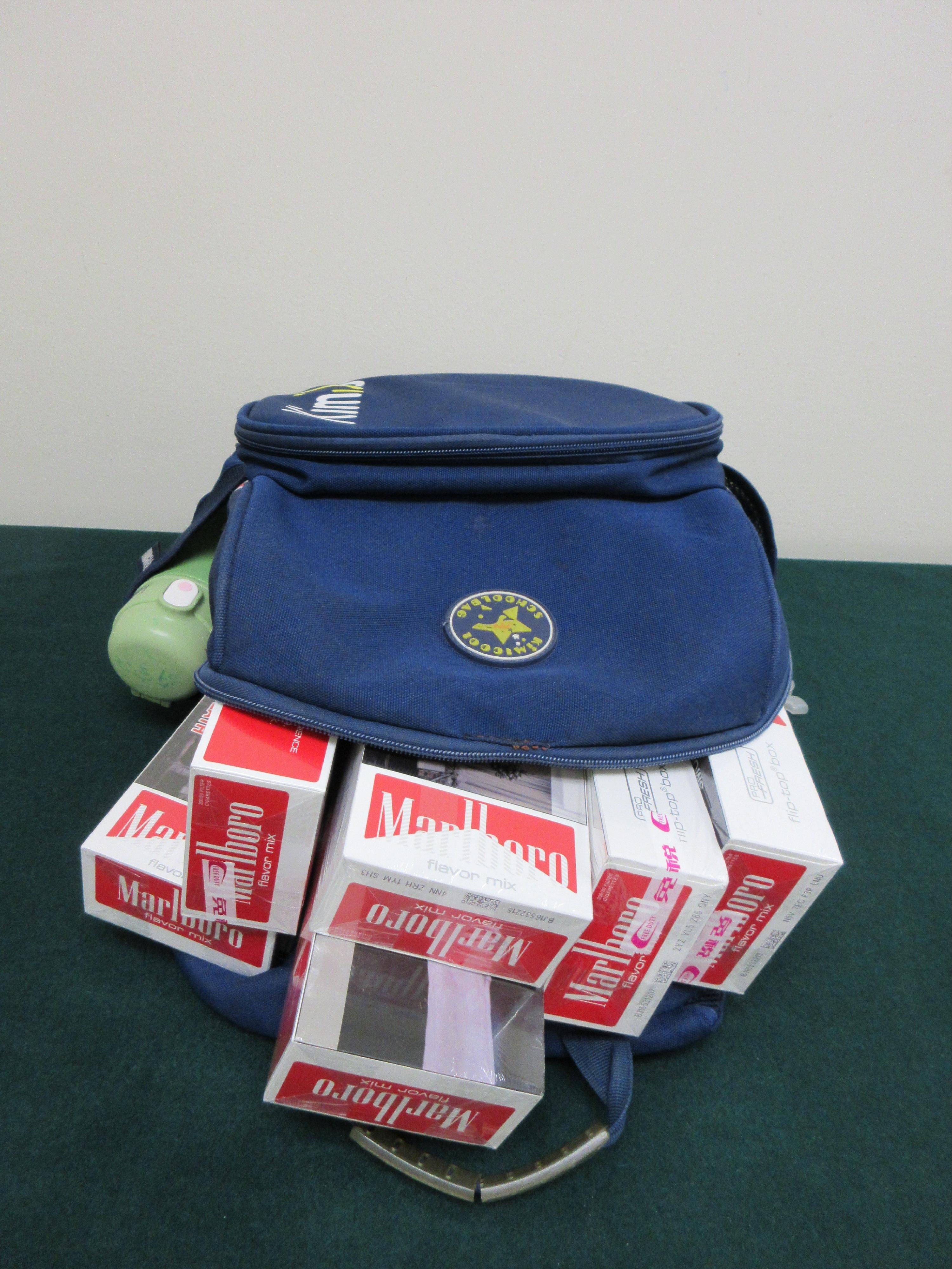 Two incoming passengers were sentenced to three months' and two months' imprisonment respectively by the Fanling Magistrates' Courts today (April 23) for possessing duty-not-paid cigarettes and failing to declare them to Customs officers in contravention of the Dutiable Commodities Ordinance. Photo shows the duty-not-paid cigarettes concealed by a 46-year-old incoming female passenger in the backpack carried by her accompanying child.