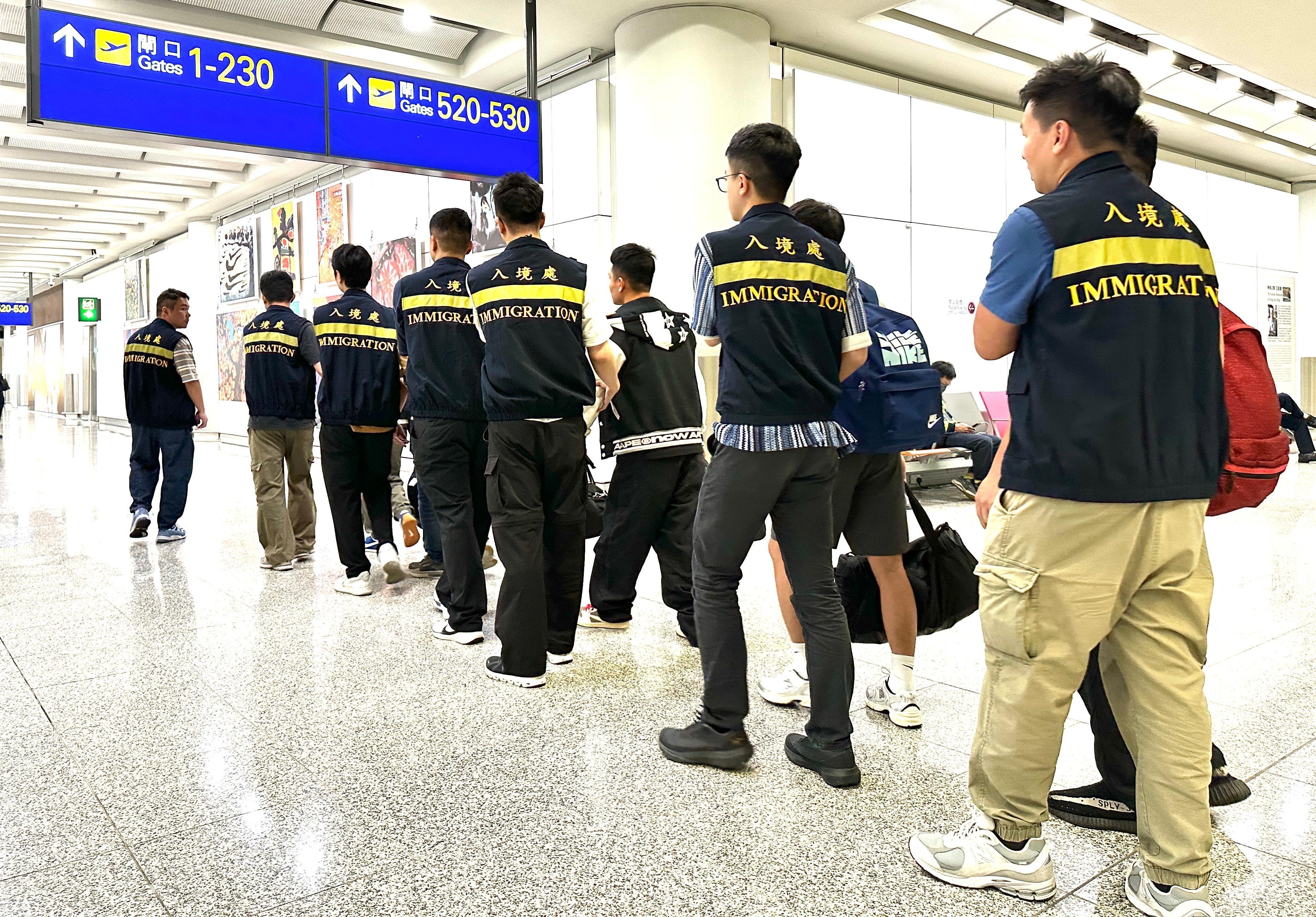 The Immigration Department (ImmD) carried out a repatriation operation today (April 24). A total of 30 Vietnamese illegal immigrants were repatriated to Vietnam. Photo shows removees being escorted by ImmD officers to depart from Hong Kong.