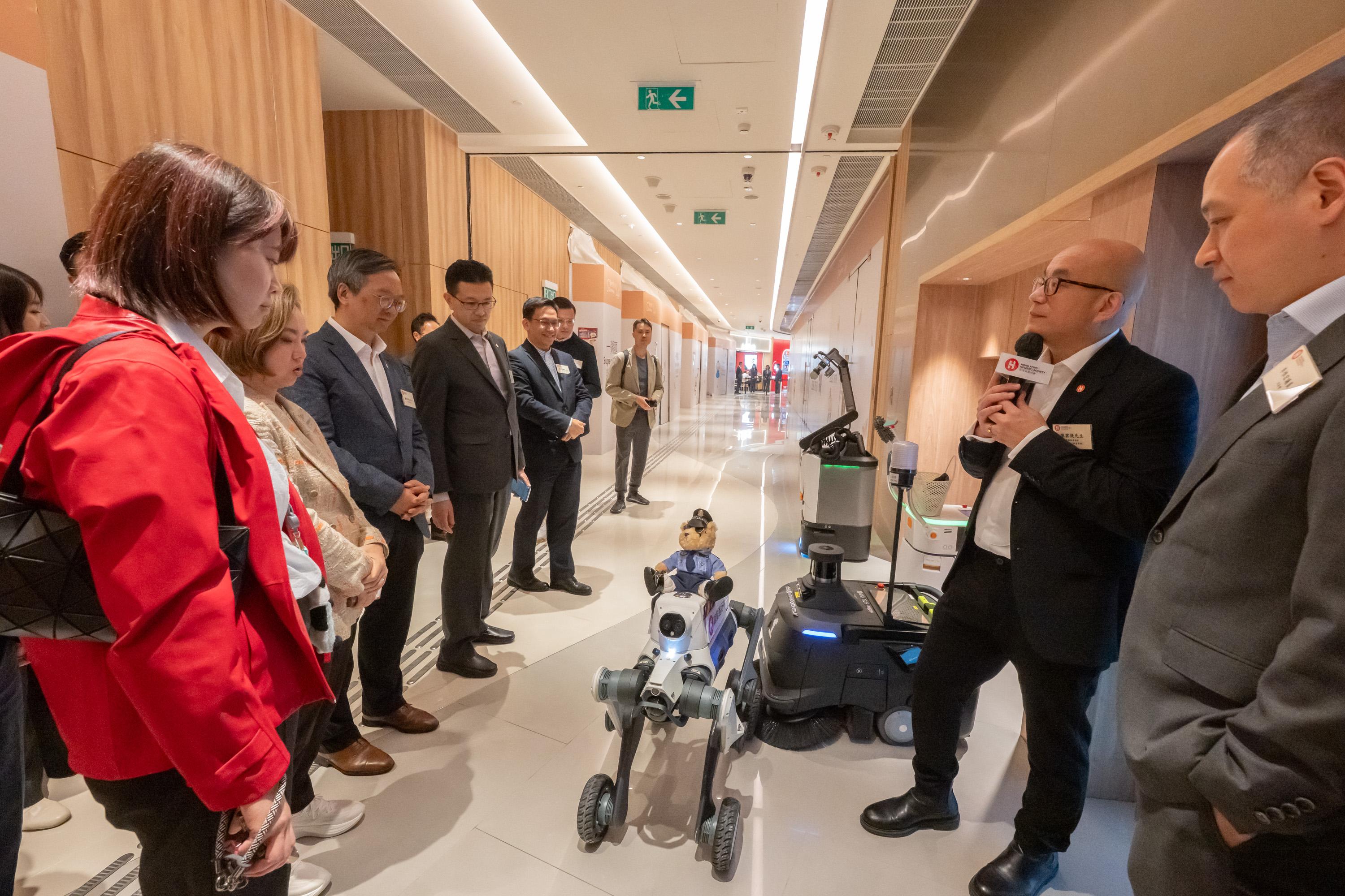 The Legislative Council (LegCo) Panel on Housing visited the Hong Kong Housing Society's (HKHS) Dedicated Rehousing Estate Casa Sierra in Fanling today (April 24). Photo shows LegCo Members observing a demonstration to learn how the HKHS uses a robotic patrol dog to improve estate management efficiency.
