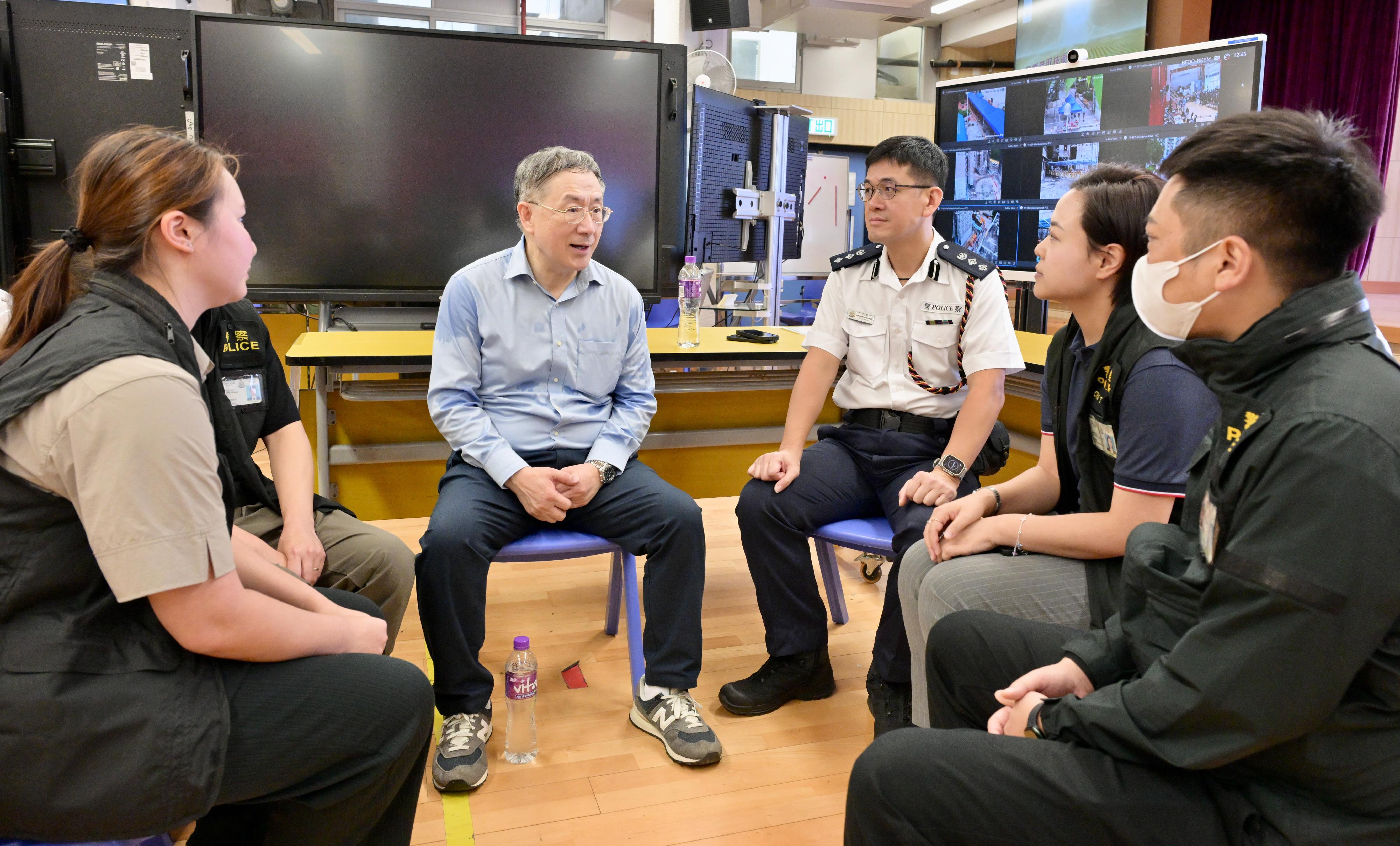 The Deputy Chief Secretary for Administration, Mr Cheuk Wing-hing, today (April 25) inspected the arrangements for residents of Wang Fuk Court in Tai Po returning to their units. Over the past few days, the District Crime Squad of Tai Po District has been handling requests from residents for police assistance. They briefed Mr Cheuk on how these cases were handled, including their efforts to help residents sift through the rubble and ashes to recover their property. Mr Cheuk said that the Police have done an excellent job in assisting residents in retrieving their items over the past few days, and encouraged them to continue with the follow-up work to safeguard residents' property. The Police place great emphasis on the arrangements for residents of Wang Fuk Court to return to their flats, and have been fully engaged in the cross-departmental operation from start to finish. Their roles include crowd management at the registration centre; traffic management in the vicinity of Wang Fuk Court; accompanying residents to and from their flats and in and out of their units; deploying officers to stand guard at the main lobby of the building and on the open floors; forming quick response teams to attend to residents who may feel unwell during their return; assisting in the opening of safes inside the flats; and helping residents move their belongings, including providing physical support when necessary.

Photo shows Mr Cheuk (second left) learning more from members of the District Crime Squad of Tai Po District handling requests from residents for police assistance. 
