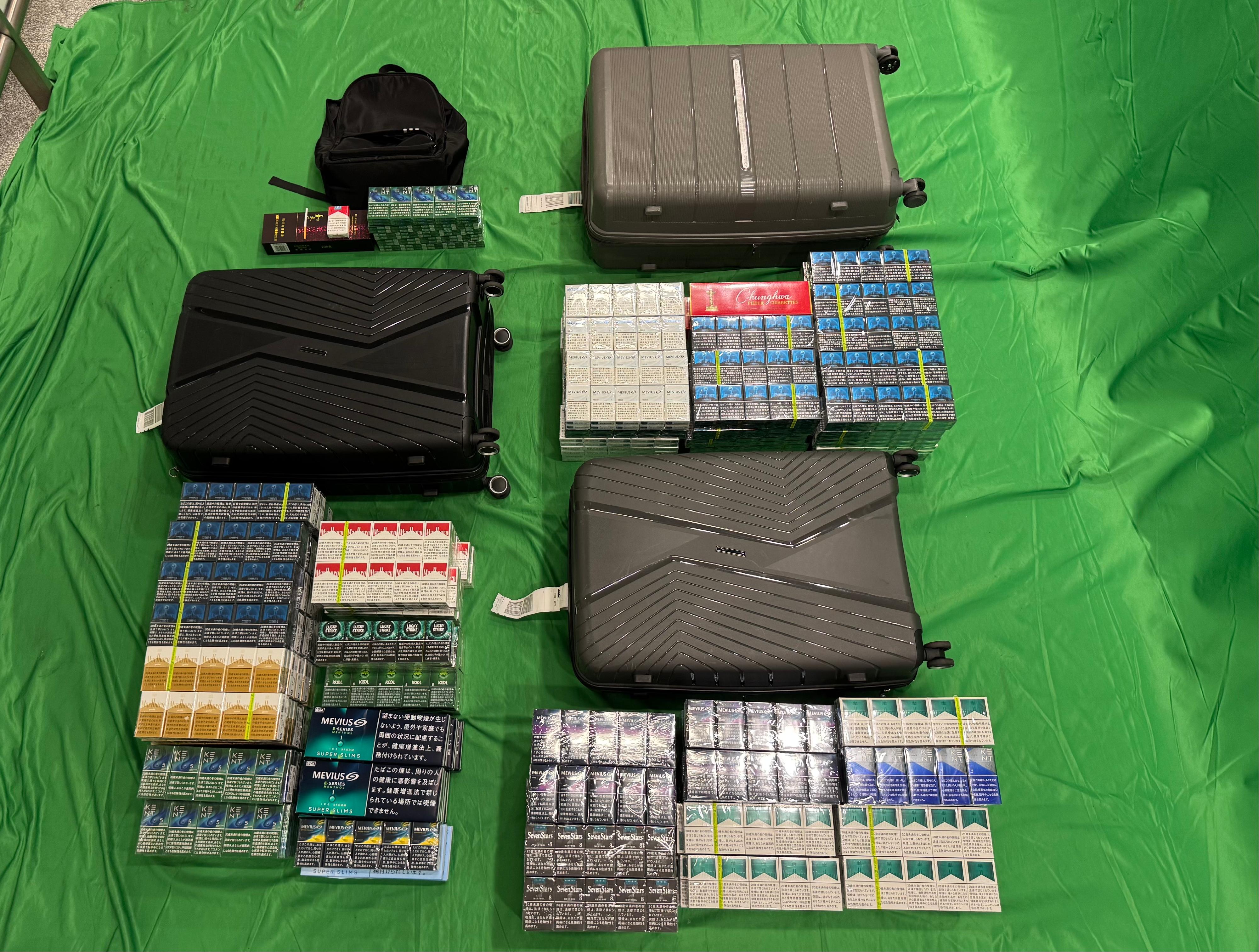 Two incoming passengers were sentenced to four months' imprisonment with a fine of $1,000 and five months' imprisonment with a fine of $1,000 respectively by the West Kowloon Magistrates' Courts today (April 27) for importing duty-not-paid cigarettes and failing to declare them to Customs officers, in contravention of the Dutiable Commodities Ordinance. Photo shows the duty-not-paid cigarettes seized from the personal baggage of a 30-year-old incoming male passenger. 
