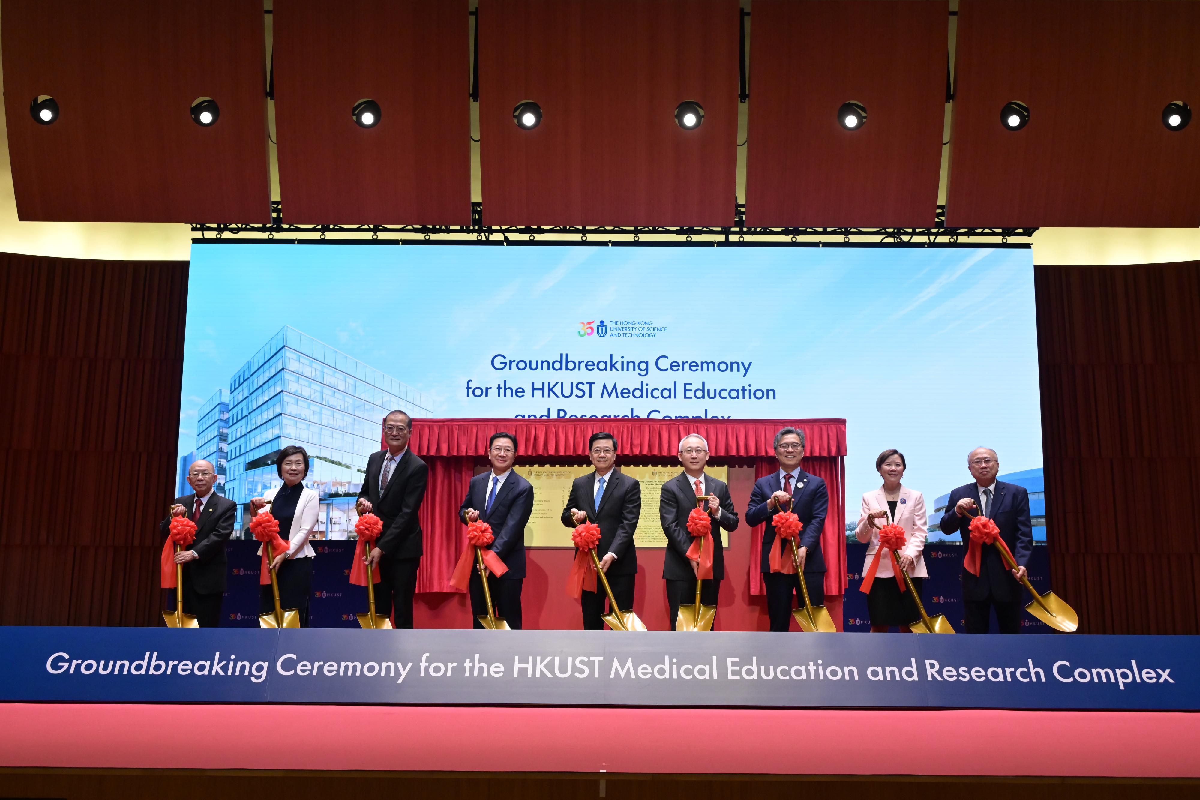 The Chief Executive, Mr John Lee, attended the Groundbreaking Ceremony for the Hong Kong University of Science and Technology (HKUST) Medical Education and Research Complex today (April 28). Photo shows Mr Lee (centre); the Director of the Liaison Office of the Central People's Government in the Hong Kong Special Administrative Region, Mr Zhou Ji (fourth left); Deputy Commissioner of the Office of the Commissioner of the Ministry of Foreign Affairs of the People's Republic of China in the Hong Kong Special Administrative Region, Mr Li Yongsheng (fourth right); the Secretary for Health, Professor Lo Chung-mau (third left); the Secretary for Education, Dr Choi Yuk-lin (second left); the Council Chairman of the HKUST, Professor Harry Shum (third right); the President of the HKUST, Professor Nancy Ip (second right), and other guests officiating at the ceremony.