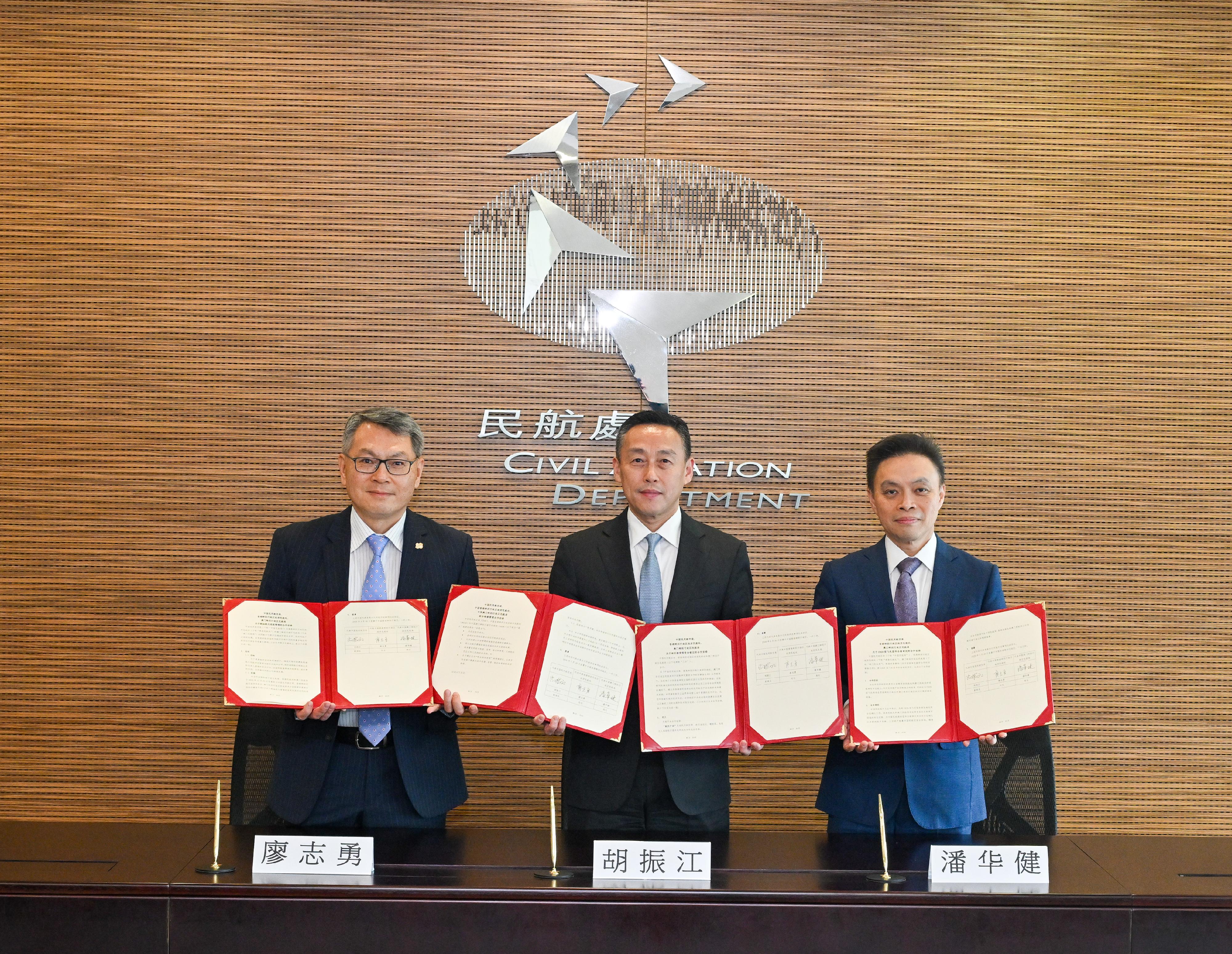 Deputy Administrator of the Civil Aviation Administration of China Mr Hu Zhenjiang (centre); the Director-General of the Civil Aviation Department of Hong Kong, Mr Victor Liu (left); and the President of the Civil Aviation Authority of Macao, Mr Stanley Poon (right), sign the Cooperation Arrangement on Mutual Acceptance of Type Certificates, the Cooperation Arrangement on Type Certification of the C929 Aircraft, the Amendment to Cooperation Arrangement on Joint Maintenance Management, and the Cooperation Arrangement on Airworthiness Management of Aviation Fuels and Chemicals at the Hong Kong Civil Aviation Department headquarters today (April 30).