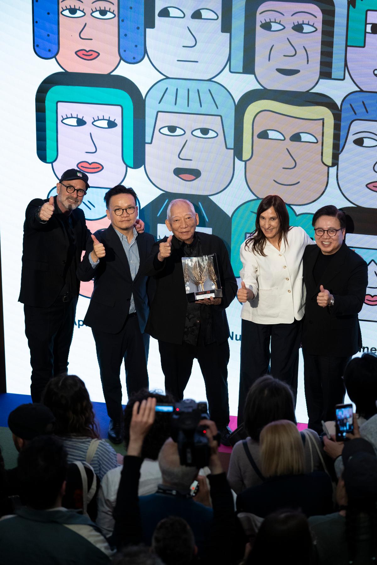 The Cultural and Creative Industries Development Agency under the Culture, Sports and Tourism Bureau, and the Hong Kong Film Development Council (FDC) led an industry delegation to participate in the 28th Far East Film Festival (FEFF) in Udine, Italy, held from April 24 to May 2 (Udine time). The delegation witnessed Hong Kong's veteran director and acclaimed action choreographer Yuen Woo-ping receiving the FEFF's Golden Mulberry Award for Lifetime Achievement. Photo shows Assistant Commissioner for Cultural and Creative Industries and the Secretary-General of the FDC, Mr Gary Mak (second left); the Chairman of the FDC, Dr Wilfred Wong (first right), and Yuen (centre), attending the closing ceremony of the FEFF in the evening on May 2 (Udine time).